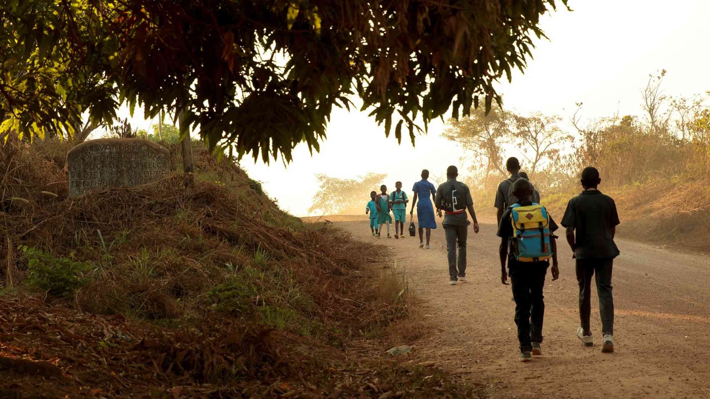 Cameroon. Children walk to school in the morning in the town of Yoko.