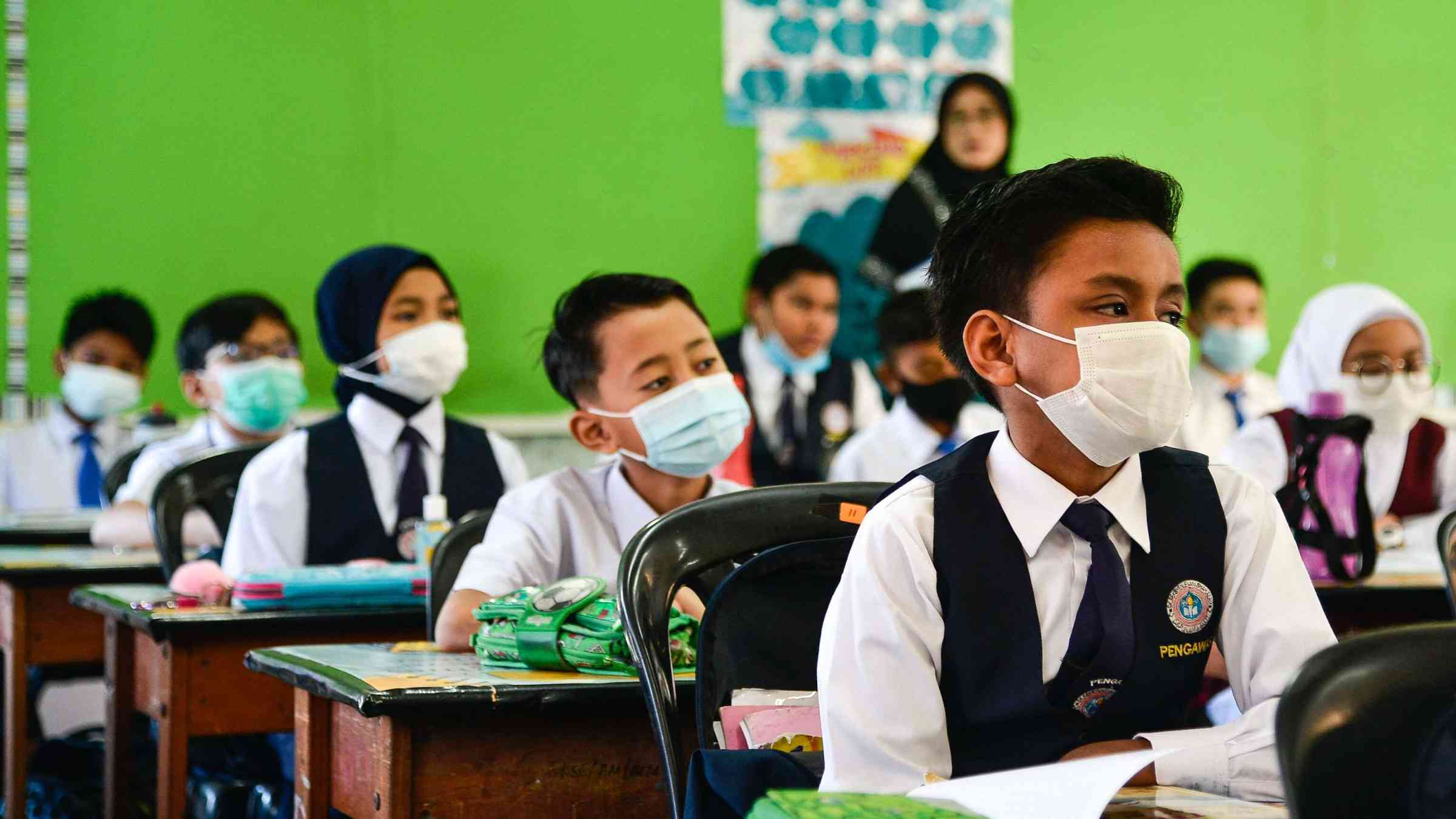 Students attend class while wearing masks in Shah Alam, Malaysia