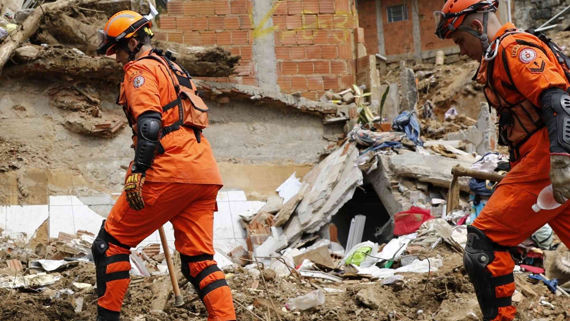 Firefighter teams conduct search and rescue for victims following a landslide and heavy rains in Petropolis city, Brazil, 25 February 2022