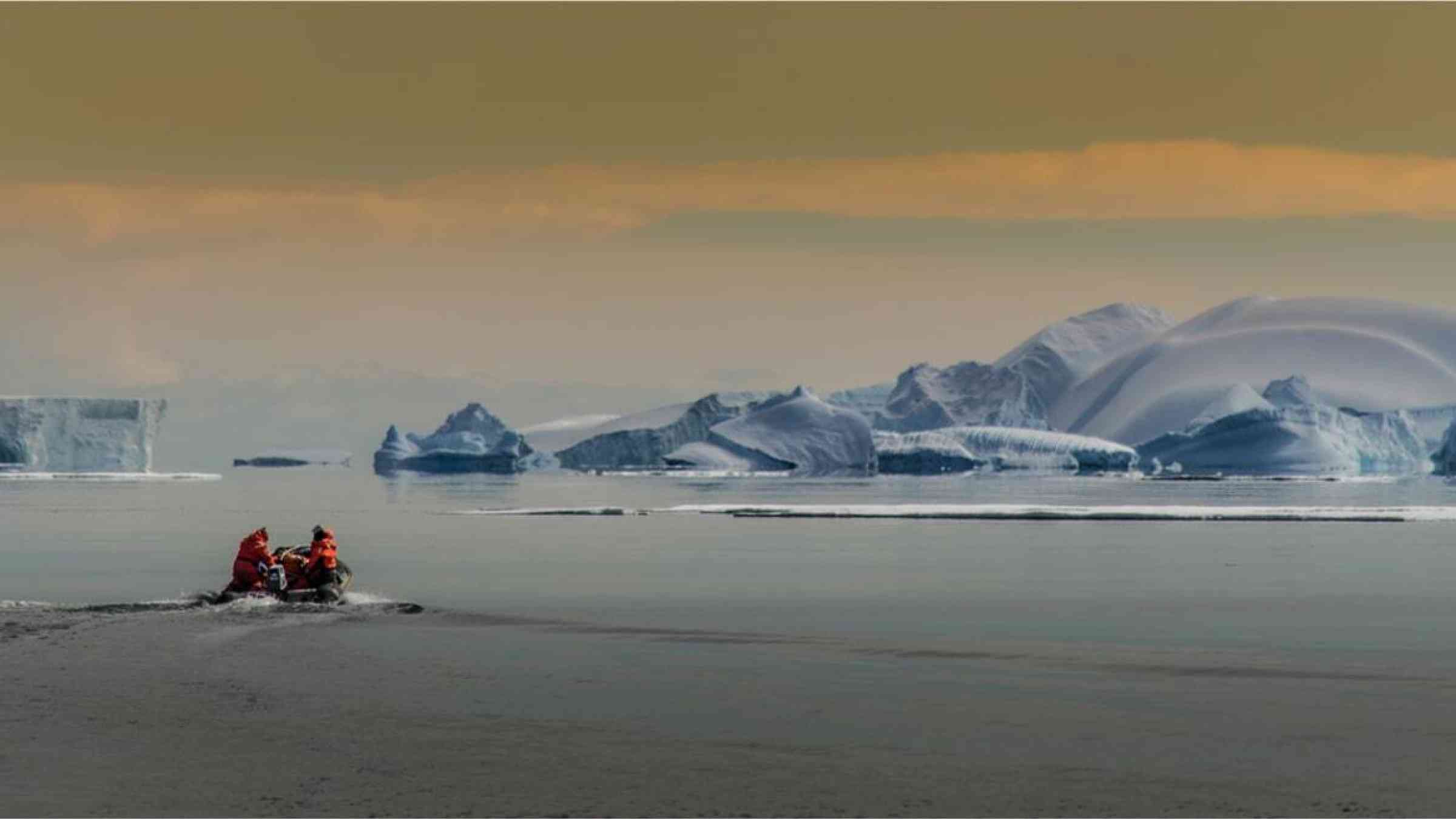 Researchers scout ice fields by boat