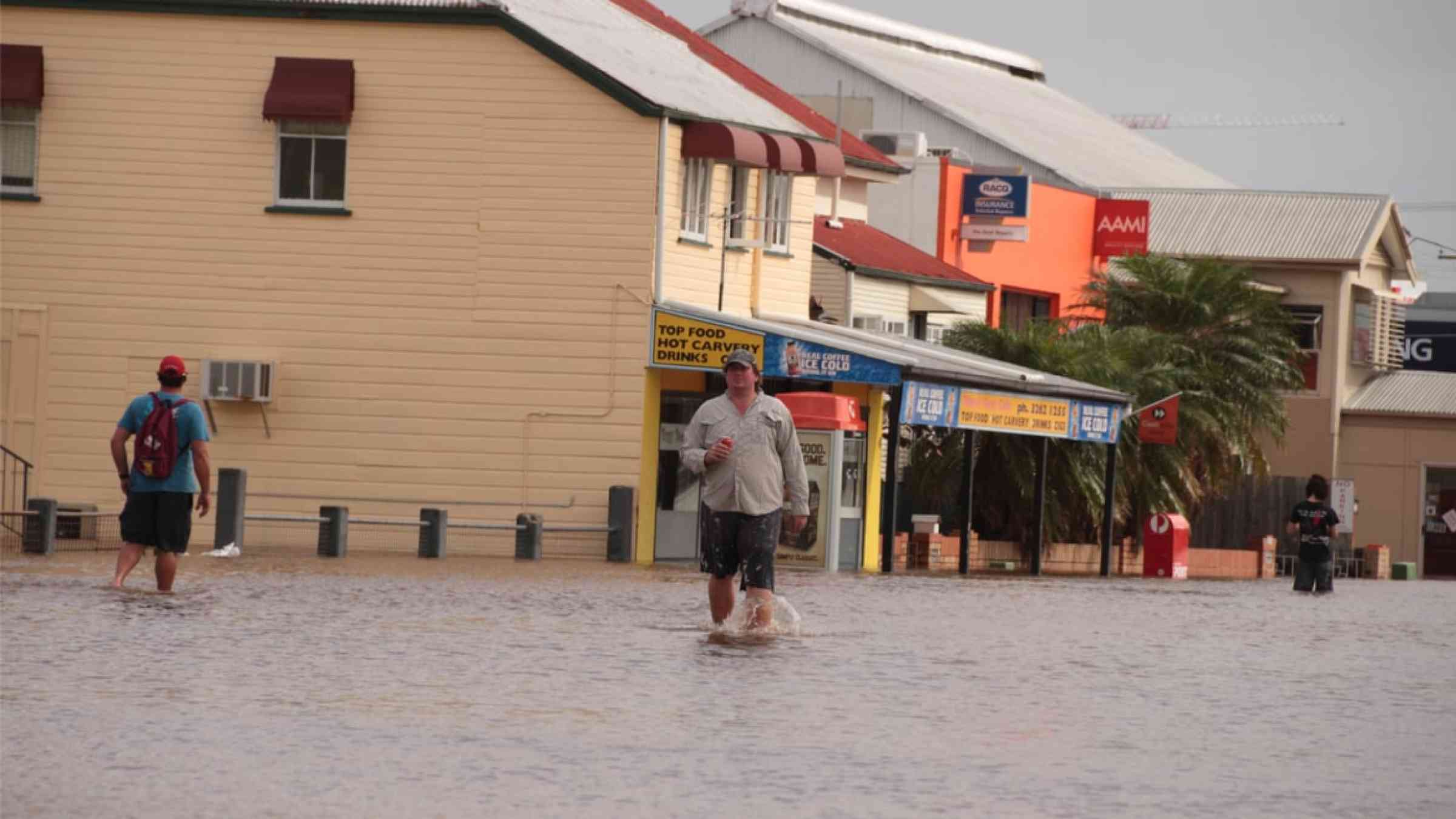 People walking through a flooded street in Brisbane, Australia (2011)
