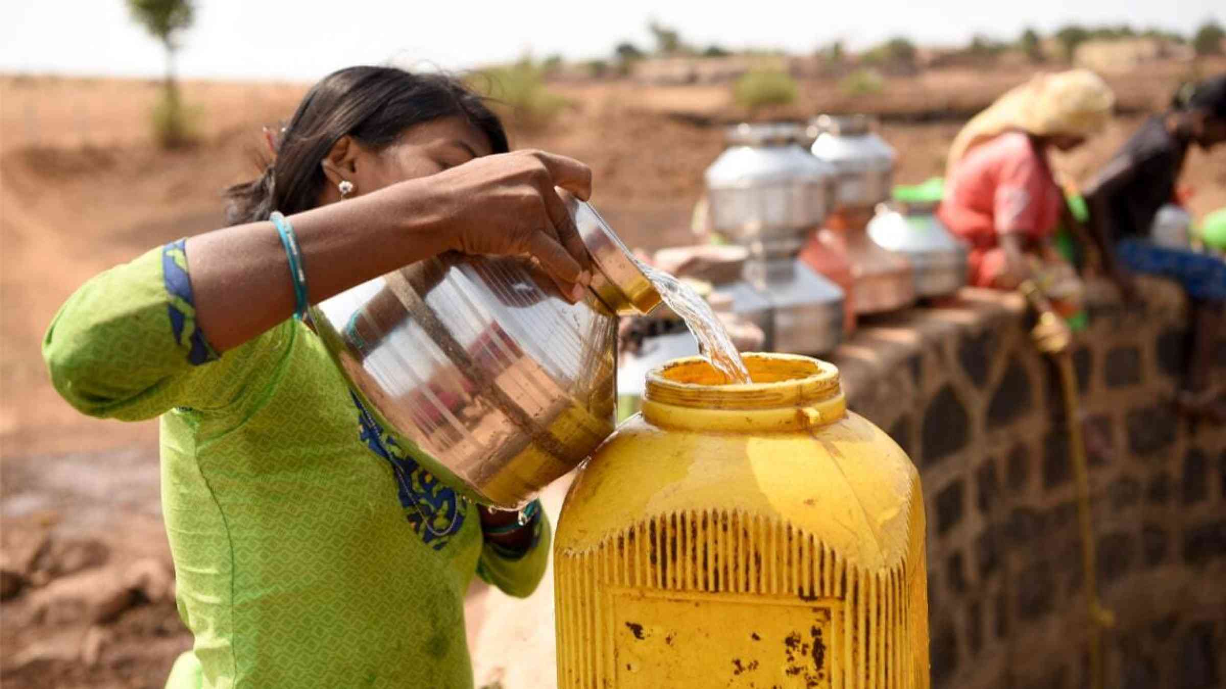 A woman fetches water from a nearly dry well at Shahapur Taluka, Maharashtra, India