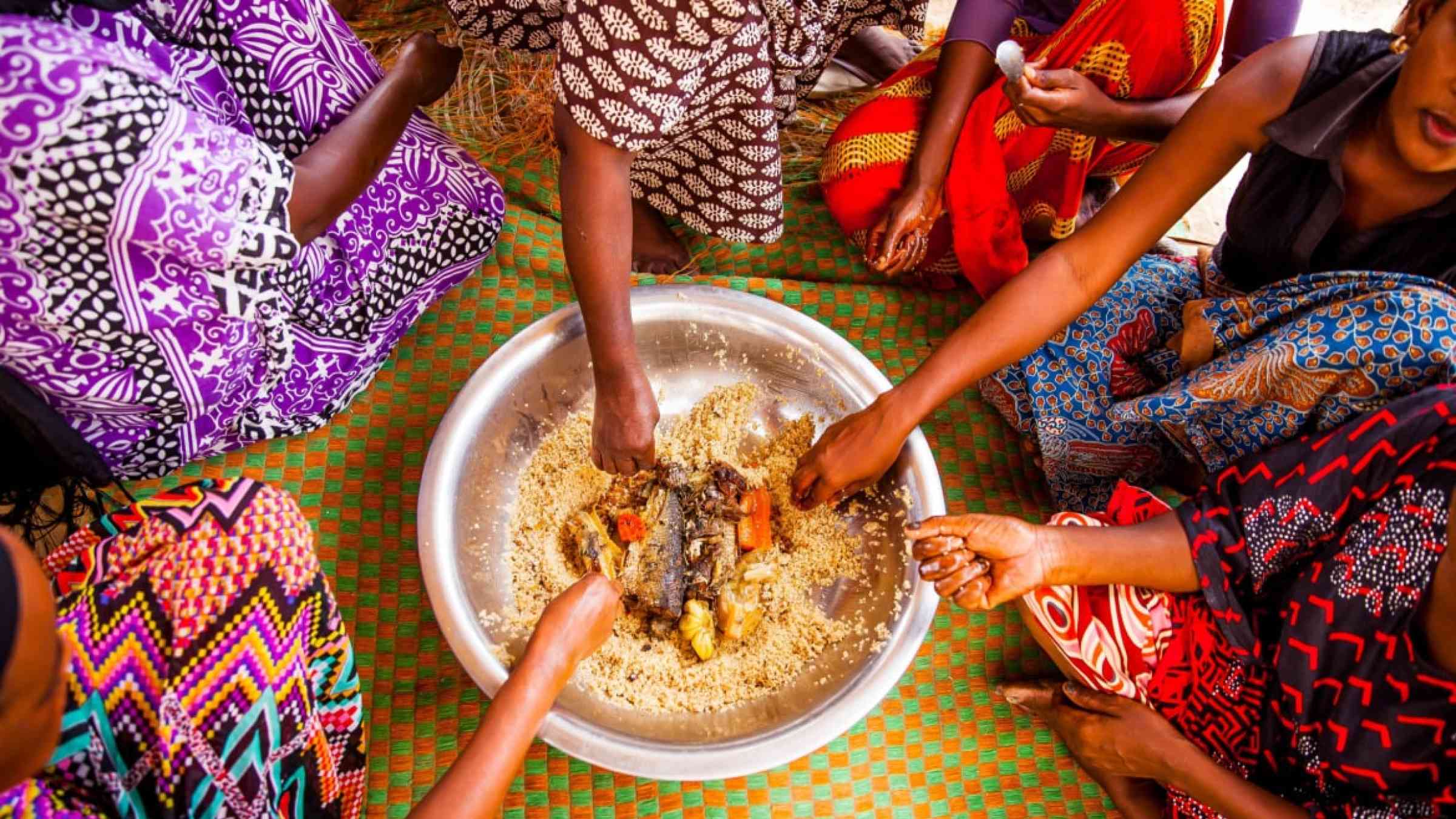 Women eating together in Senegal in the traditional manner.