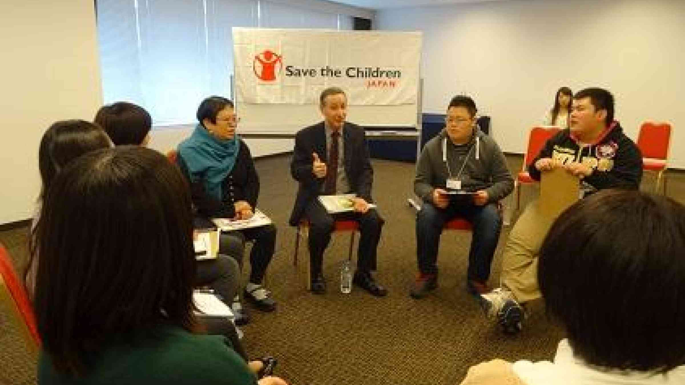 The head of UNISDR, Mr. Robert Glasser, speaking with children from the Tohoku region of Japan, who survived the 2011 Great East Japan Earthquake and Tsunami