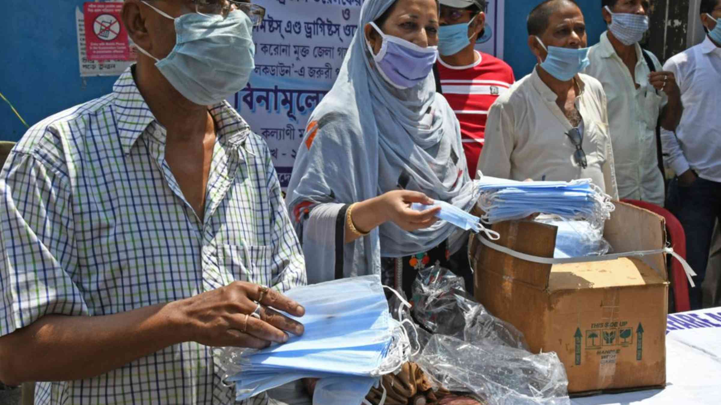 Associations distributing free masks in West Bengal, India (2020). Sanjoy Karmakar/Shutterstock