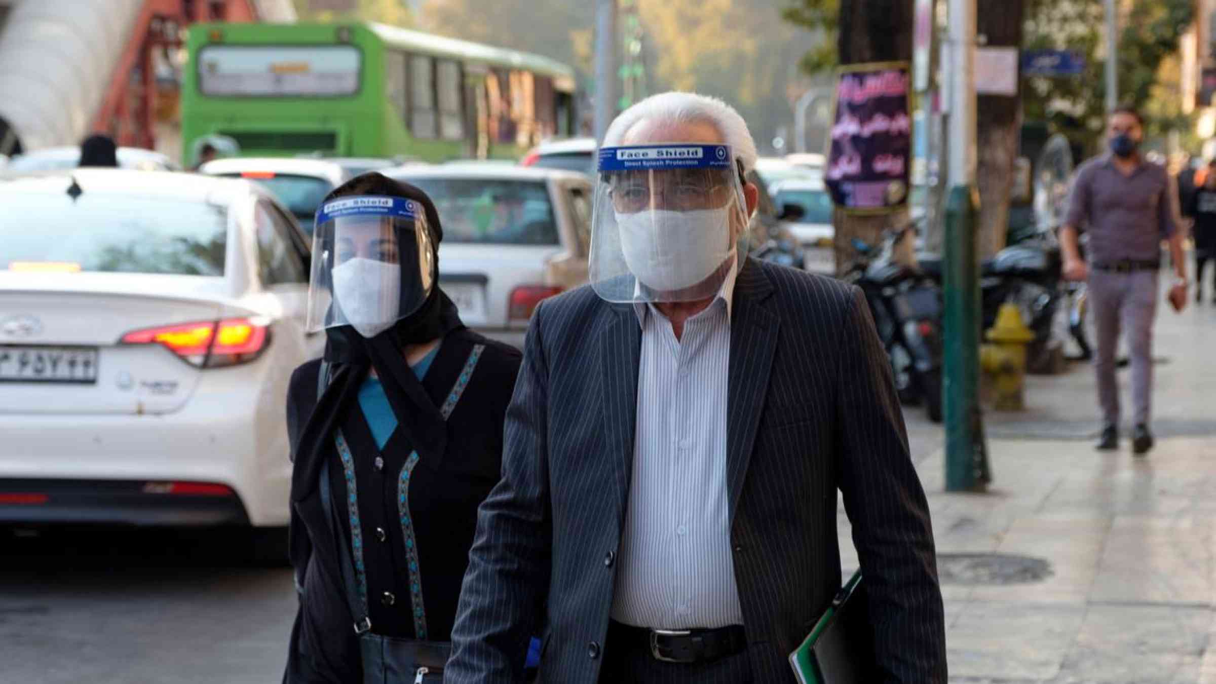 Two senior citizens walking in Tehran, Iran. Farzad Frames/Shutterstock