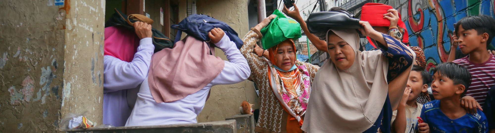 Women from Kampung Braga in Bandung, Indonesia, perform a disaster preparedness simulation