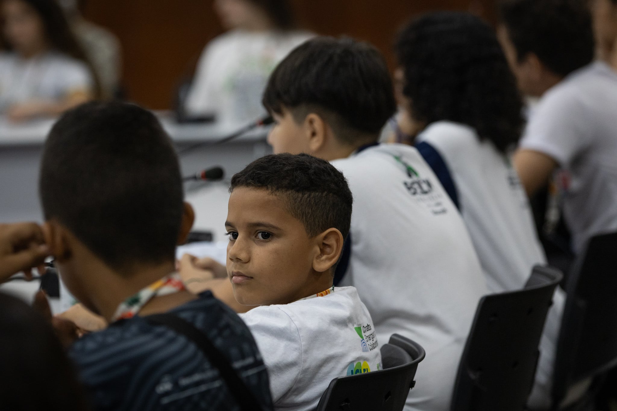 boy looking at colleague during a COP plenary meeting
