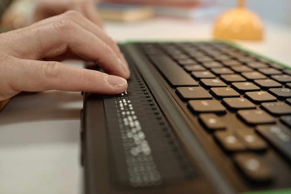 Person reading with braille