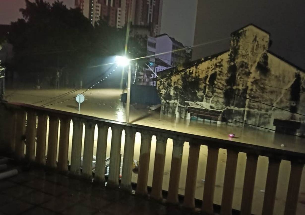 A view of floodwaters outside Elizabeth Chong's family home in Kuala Lumpur, Malaysia. December 18 2021. Thomson Reuters Foundation/Elizabeth Chong