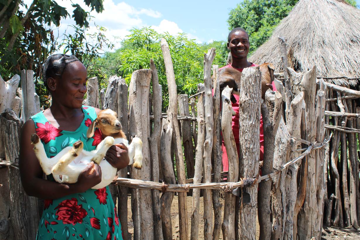 Farmer Tulibamlie Mudenda poses with one of the kids born after she started breeding her indigenous goats with a larger Boer buck, in Binga, Zimbabwe, February 24, 2022. Thomson Reuters Foundation/Busani Bafana