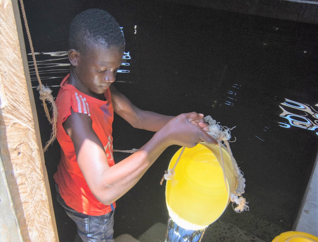 Boy collecting water from the cistern
