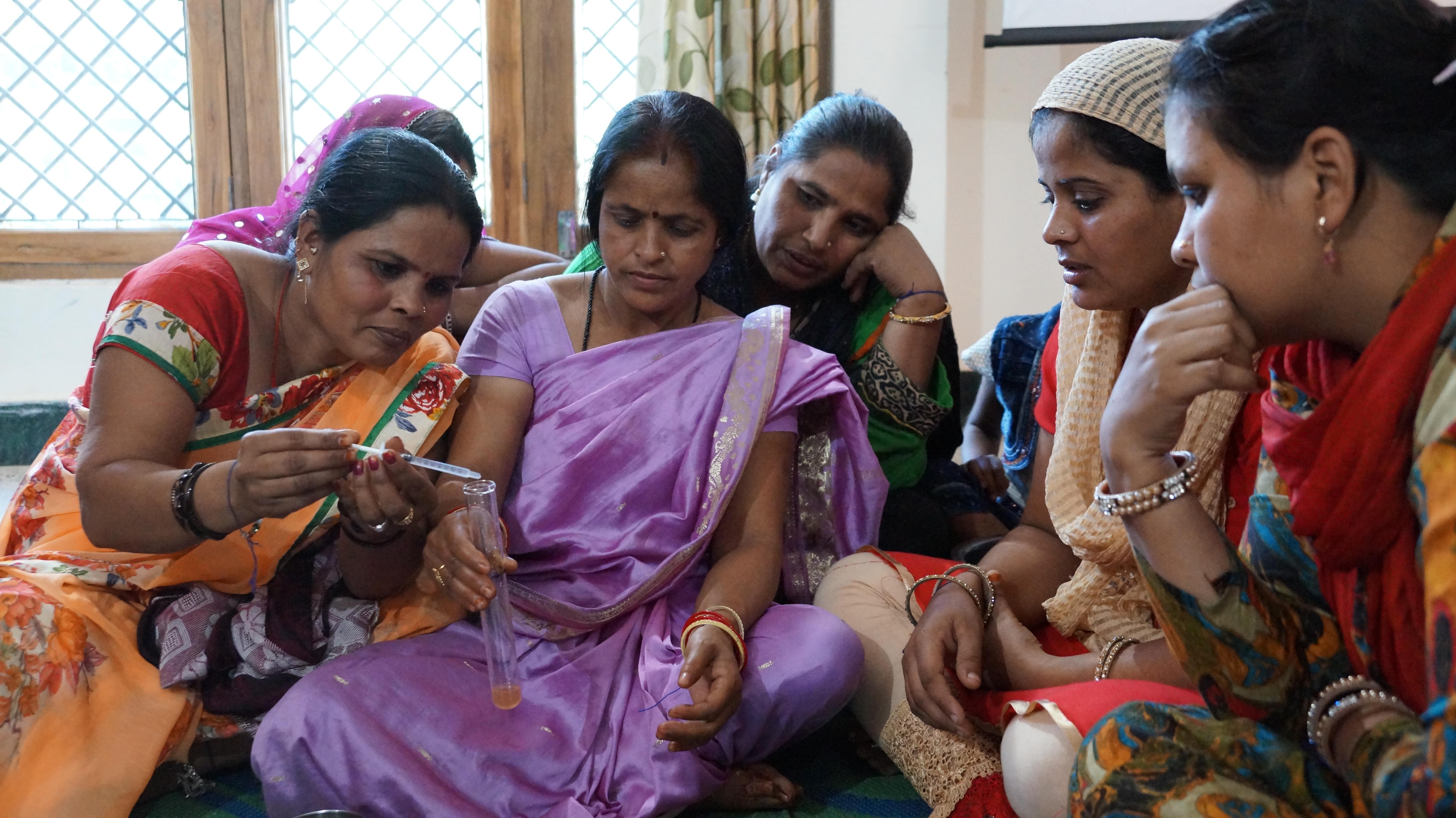 Women learning how to test water quality