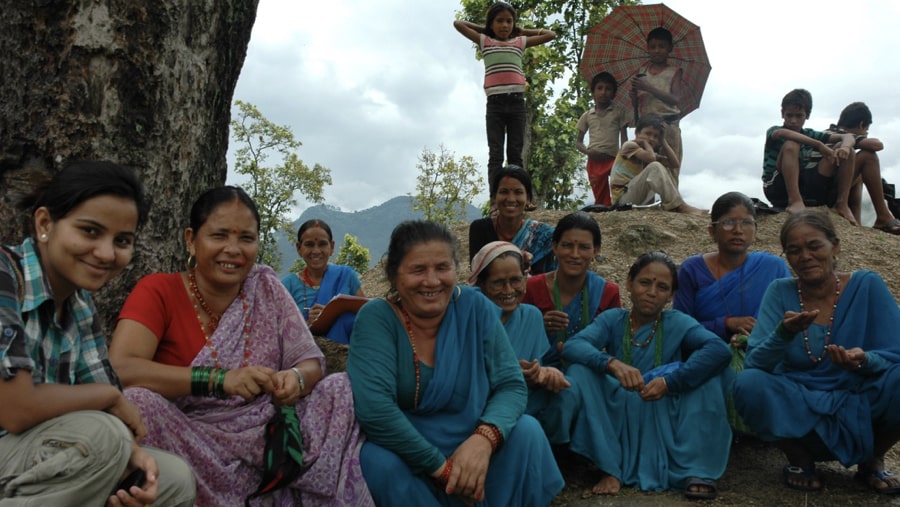 Manisha posing for a photograph with local women