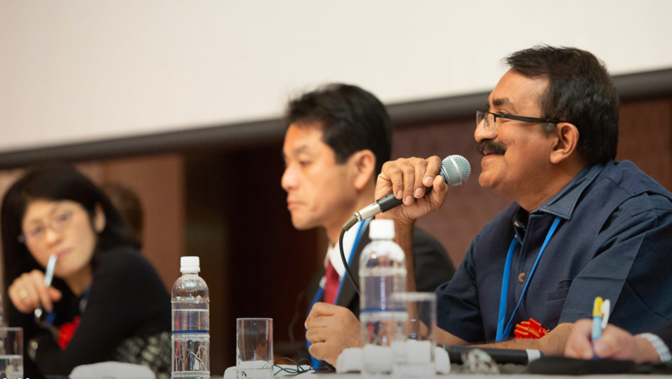A person speaks enthusiastically on a panel at the International Recovery Forum 2019, run by UNDRR's International Recovery Platform.