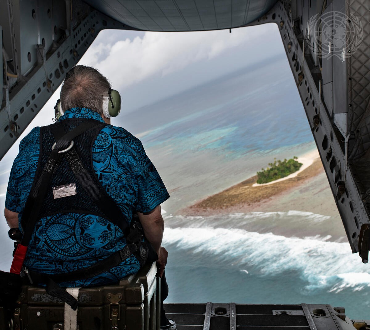 Figure 8. Secretary-General António Guterres looks out over the islands of Tuvalu from the back of the plane during his flight there in 2019. UN Photo/Mark Garten
