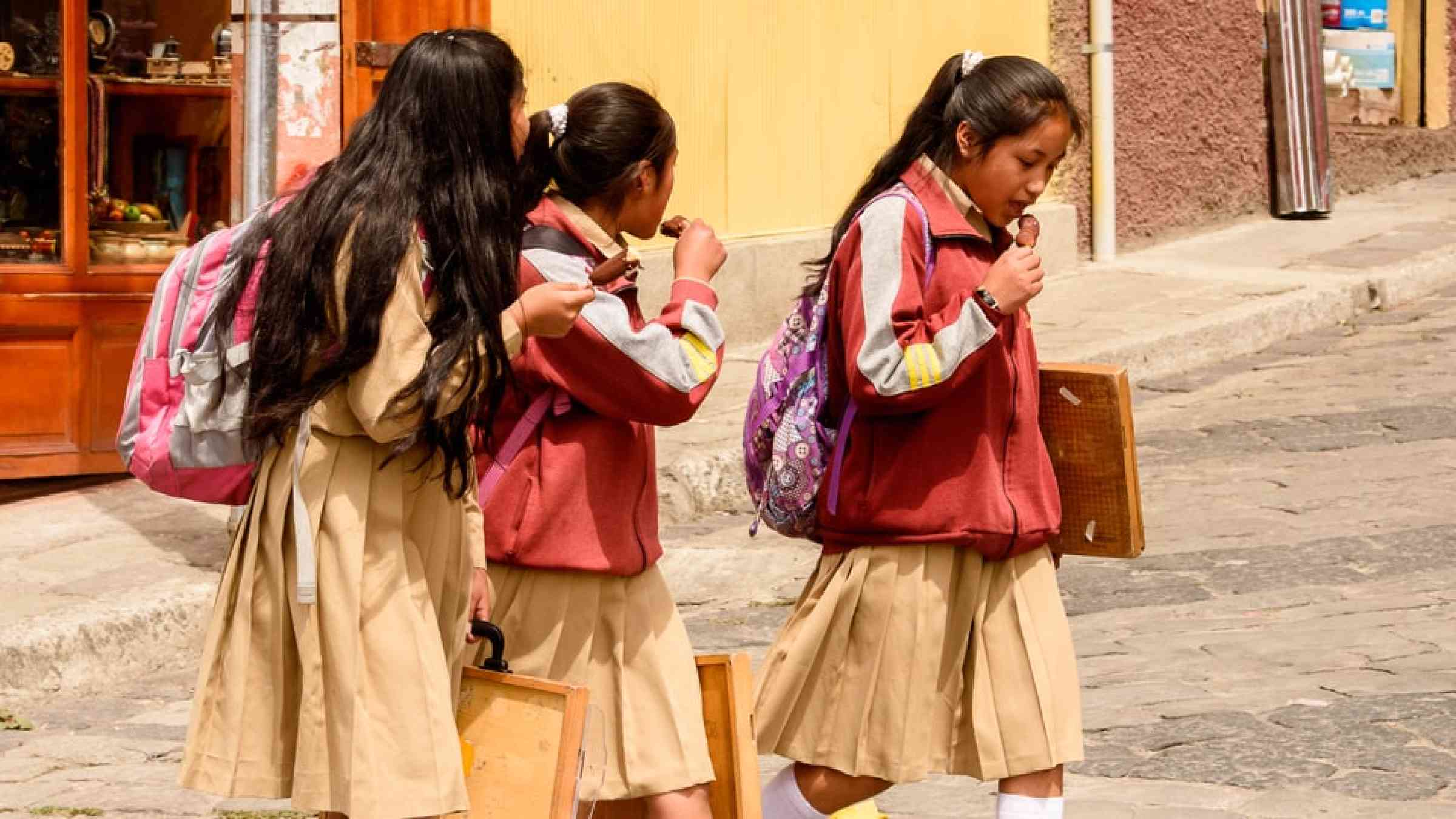 School girls walk in the street in Ecuador