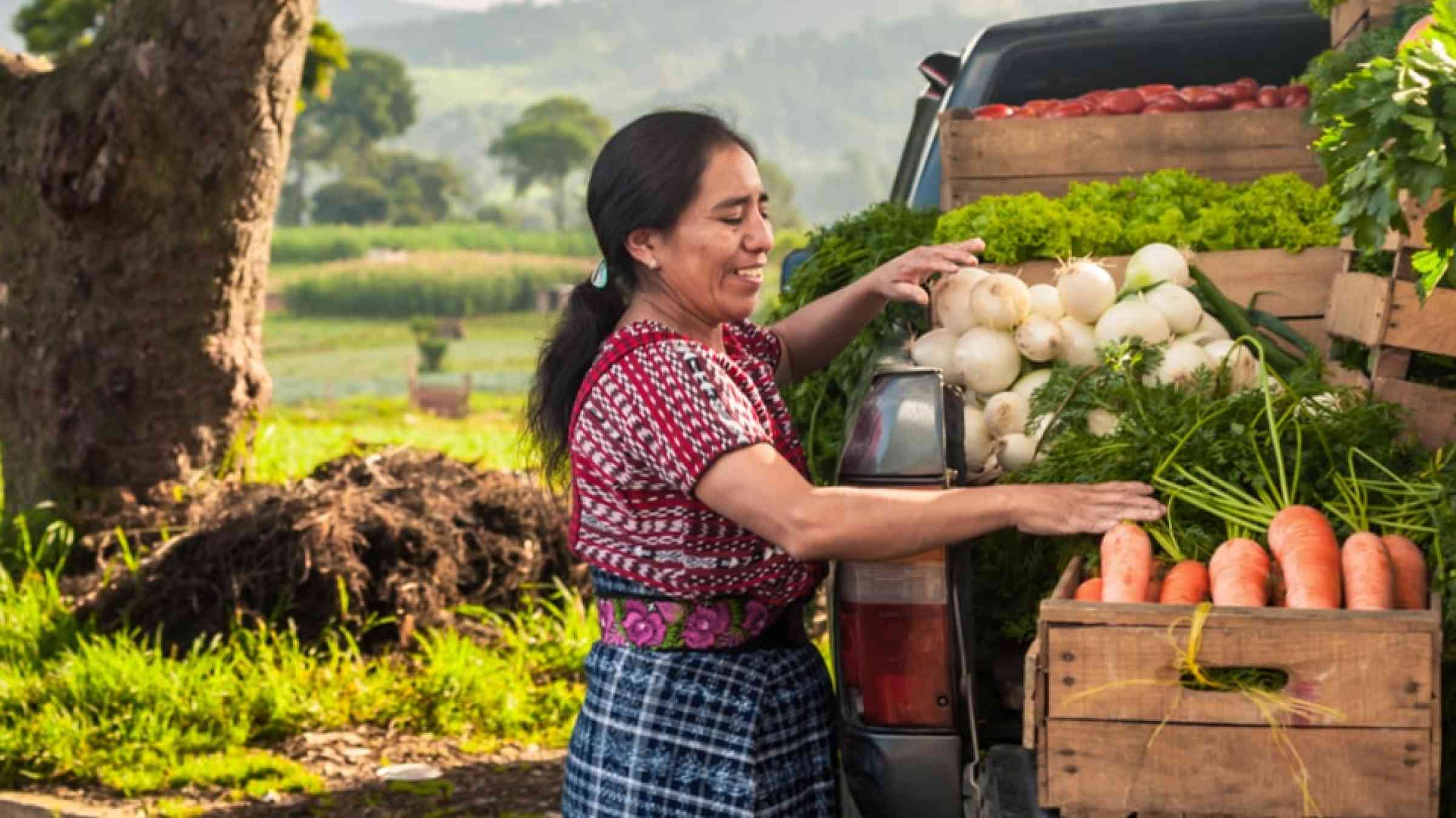 Woman with her truck full of vegetables