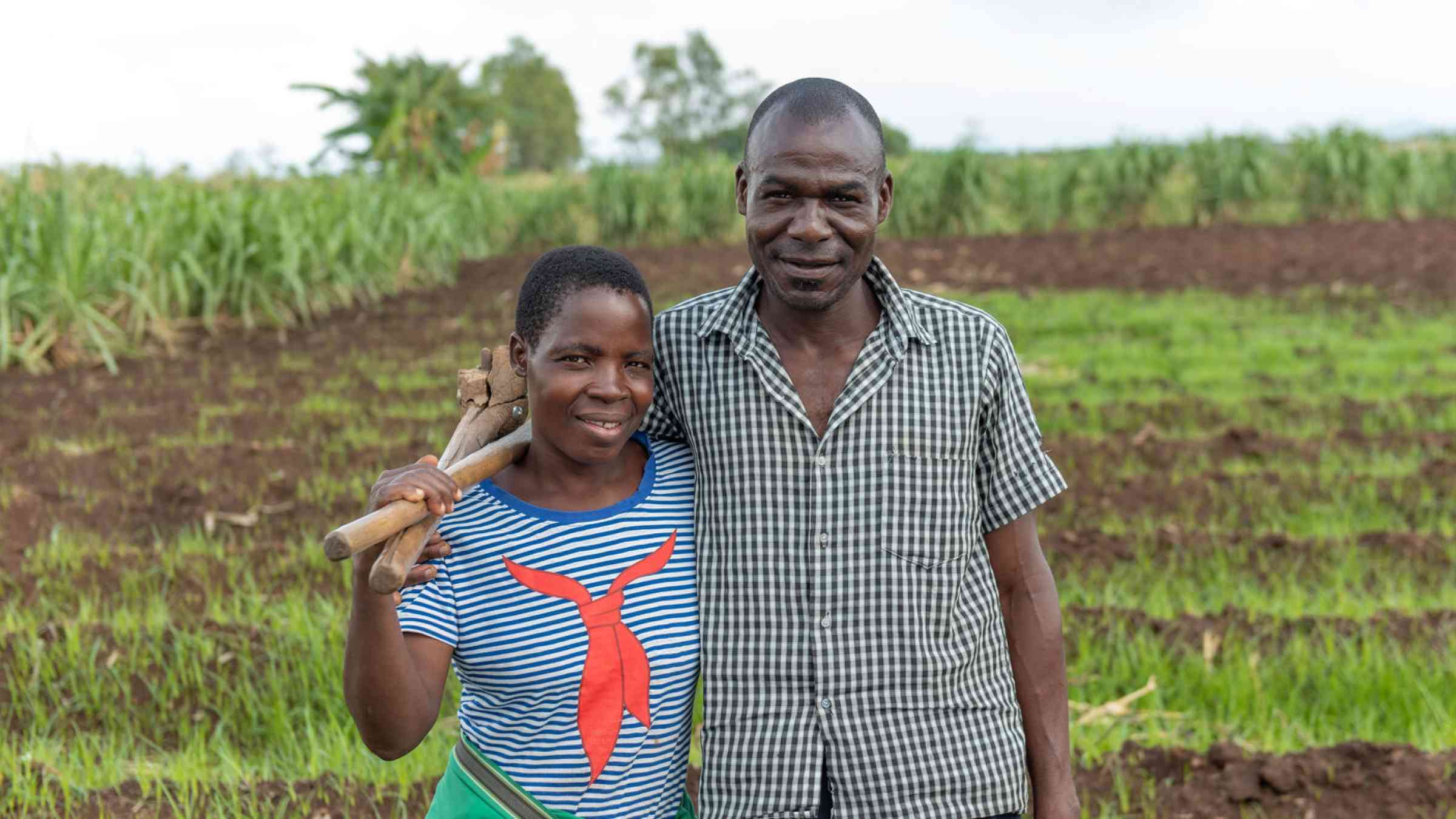 John Mphaya and his wife, Esinala Samuel Smiling to the camera while at their field