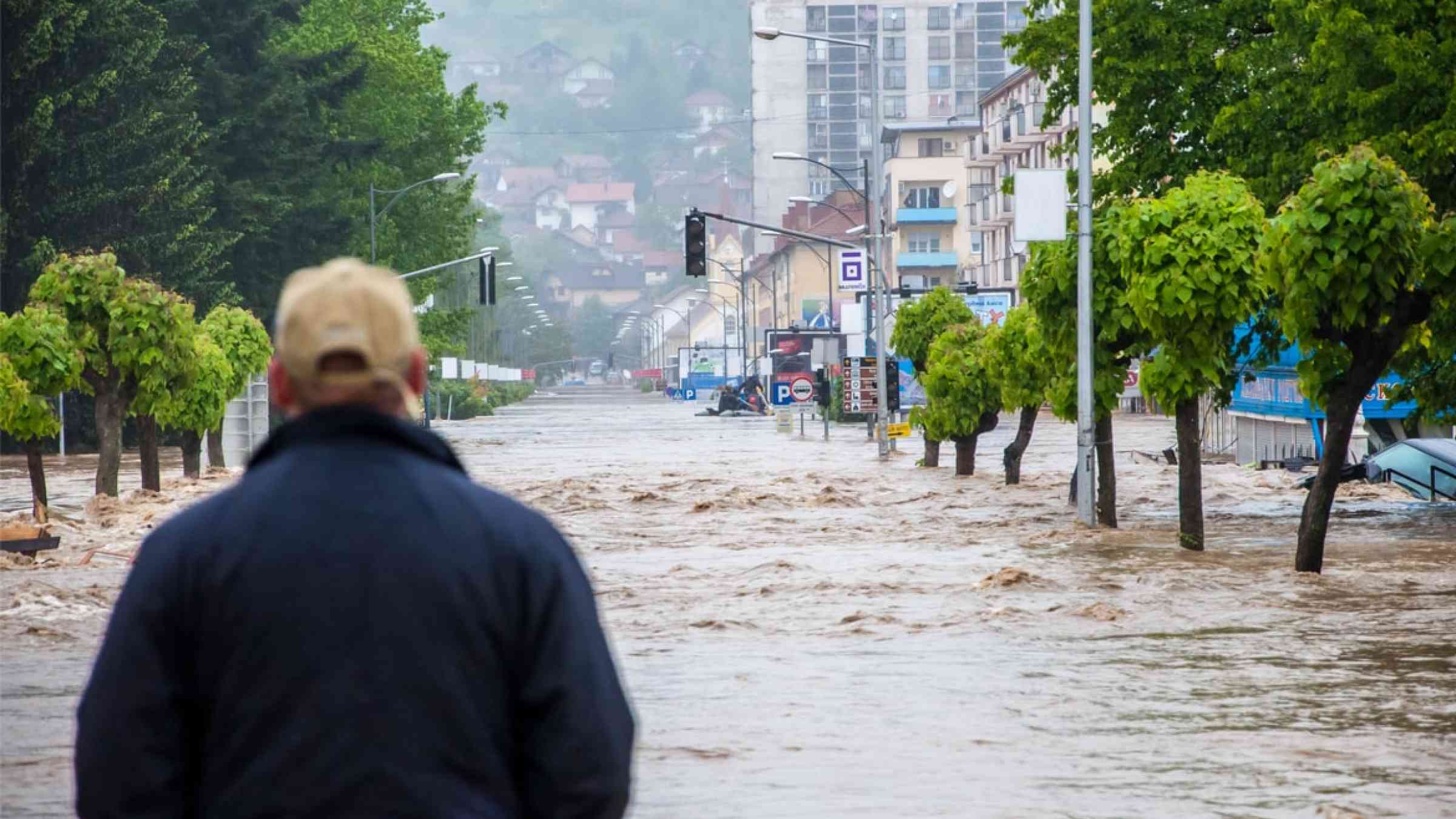 Man looking at a flooded street in Bosnia (2014)