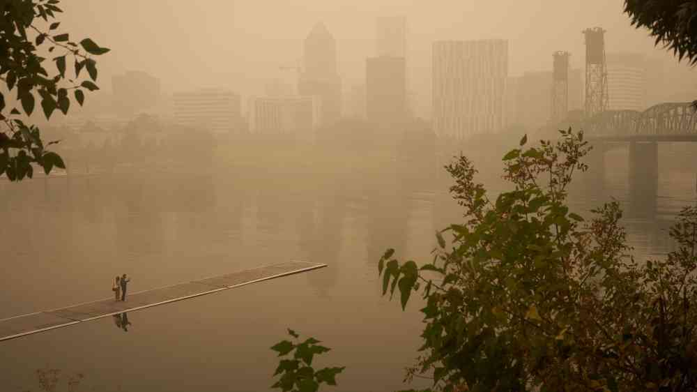 Portland, OR, USA - Sep 12, 2020: An orange smoke-filled sky is seen above Portland's downtown skyline on Saturday afternoon during the Oregon wildfires.