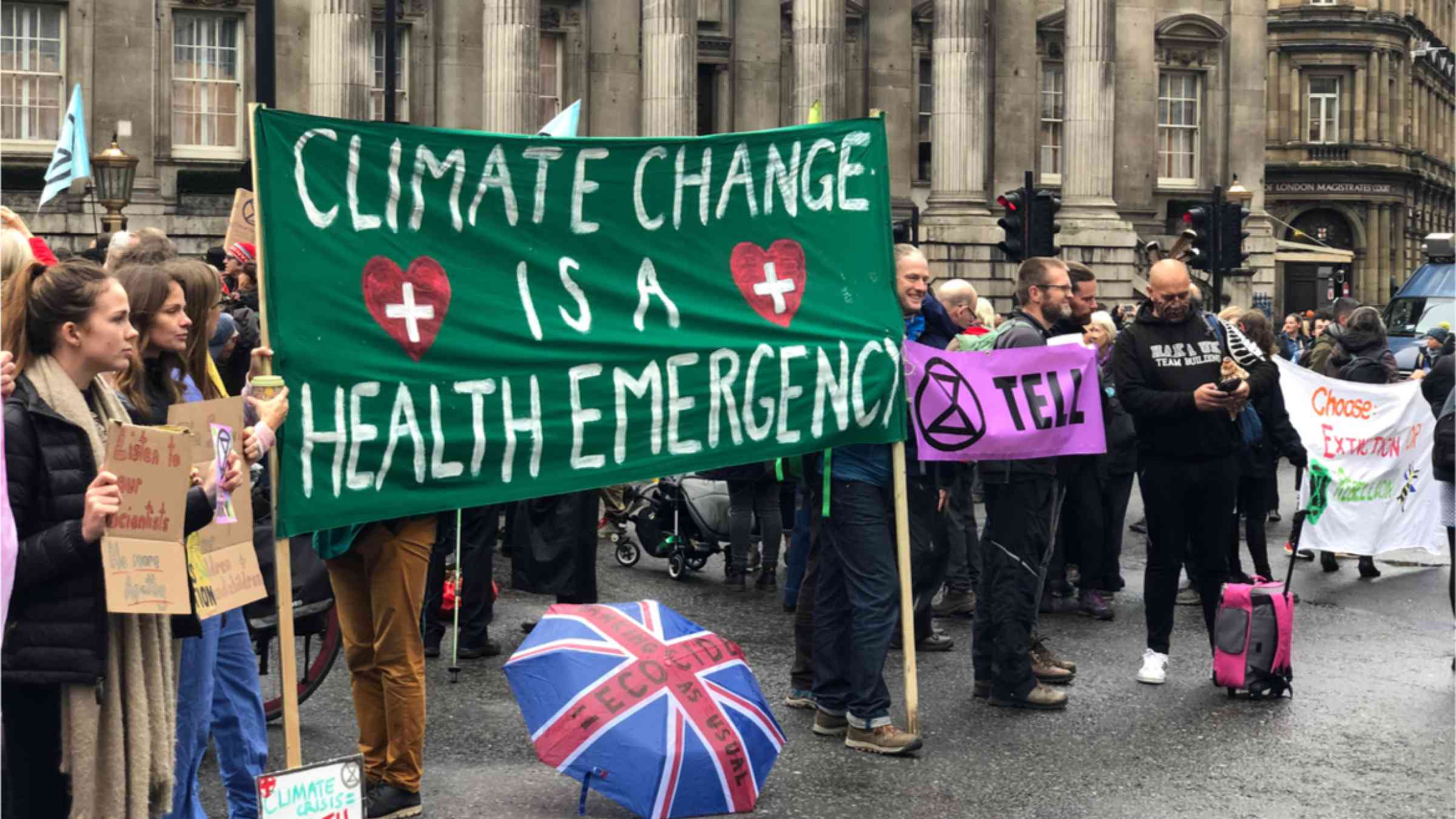 The Extinction Rebellion protesting climate change while occupying Bank, London with a sign reading "Climate Change is a Health Emergency"