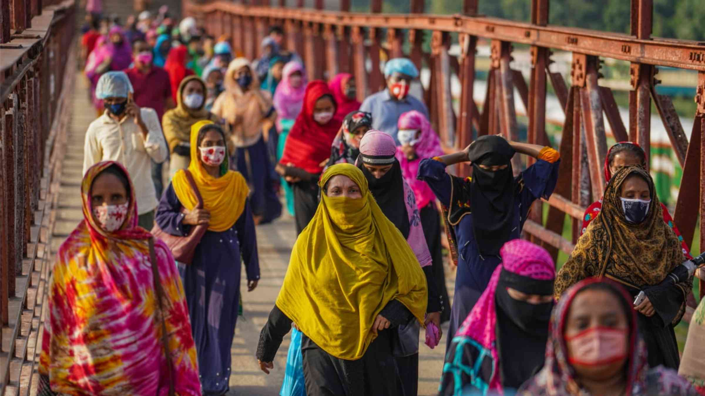 Garment workers wearing face masks walking on the street as they go home during the COVID-19 coronavirus pandemic in Dhaka, Bangladesh (2020)
