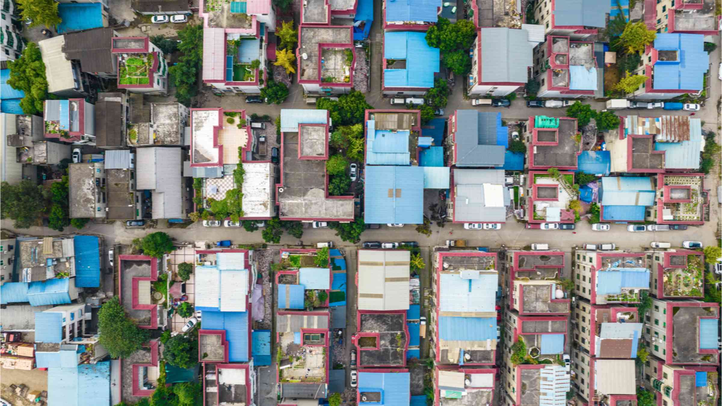 Aerial view of residential buildings with blue roofs.