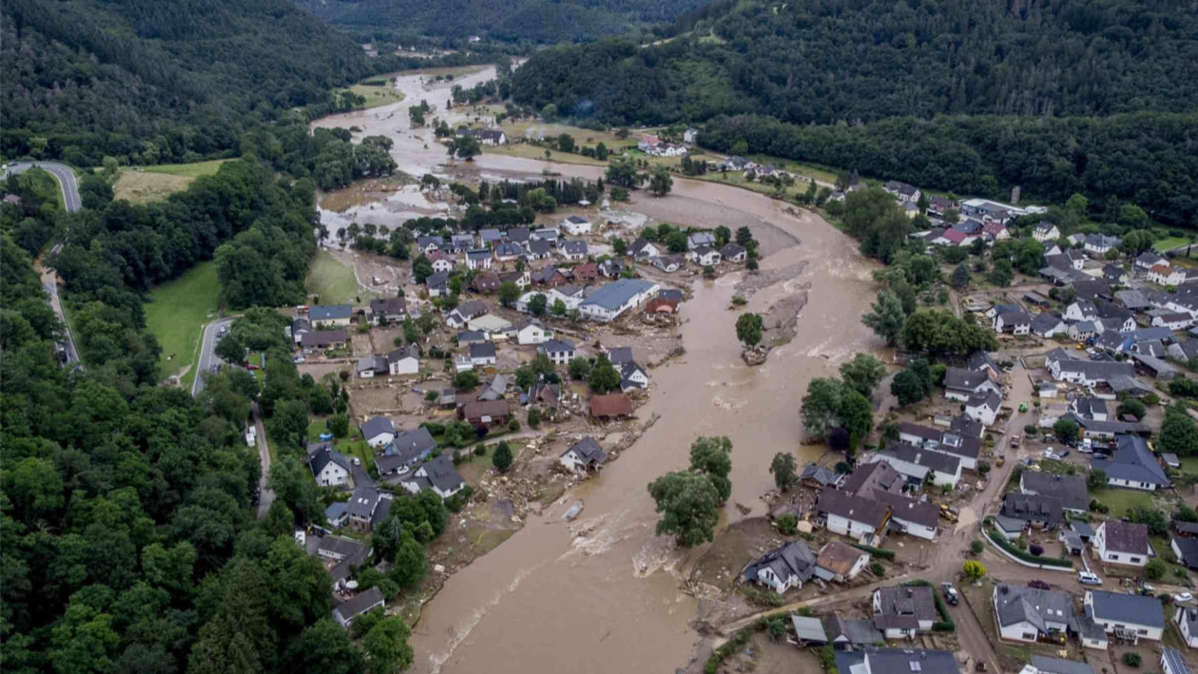 The Ahr river flows past houses destroyed by floods in Insul, Germany (2021)