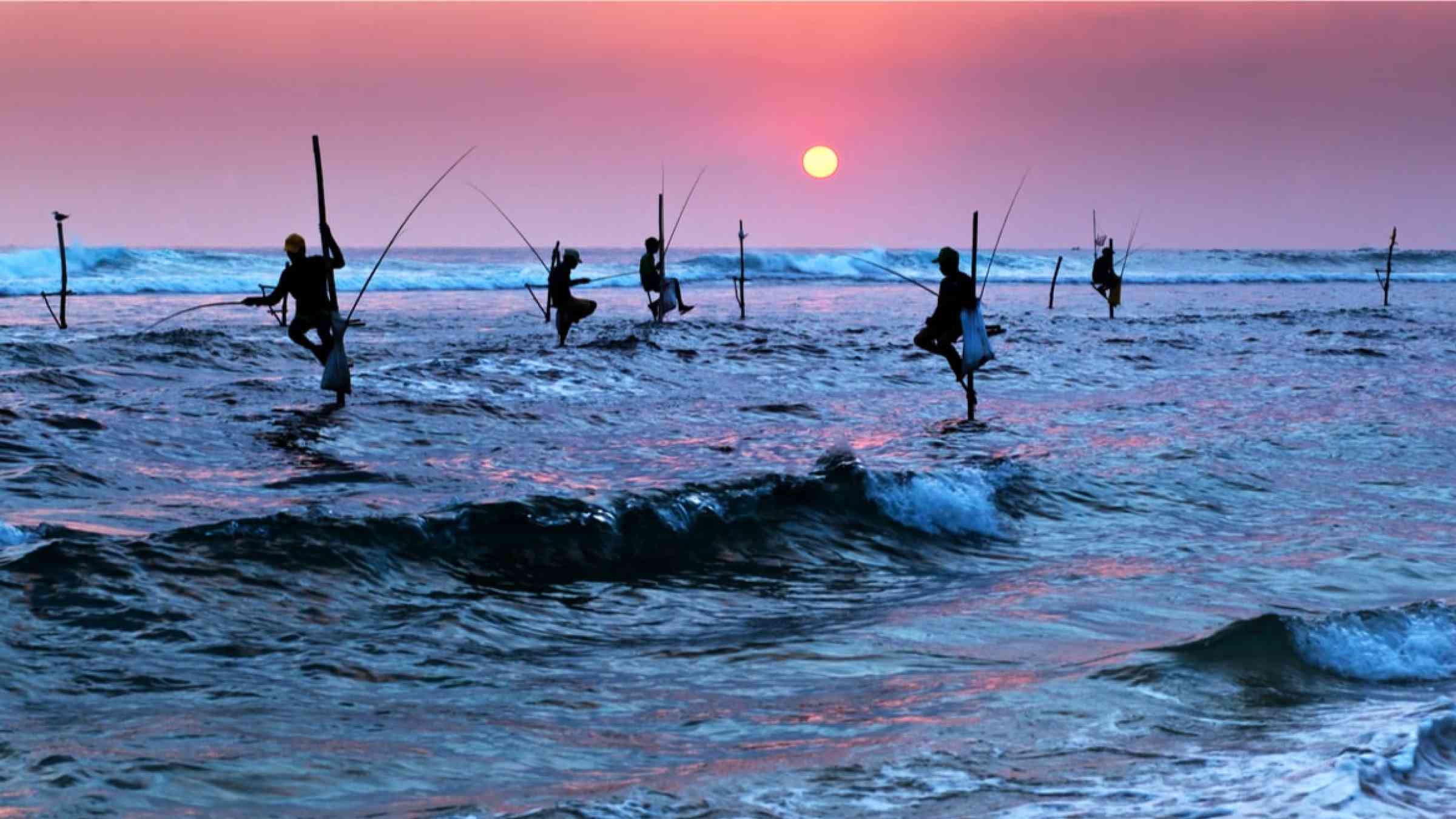Silhouetes of traditional fishermen in Sri Lanka