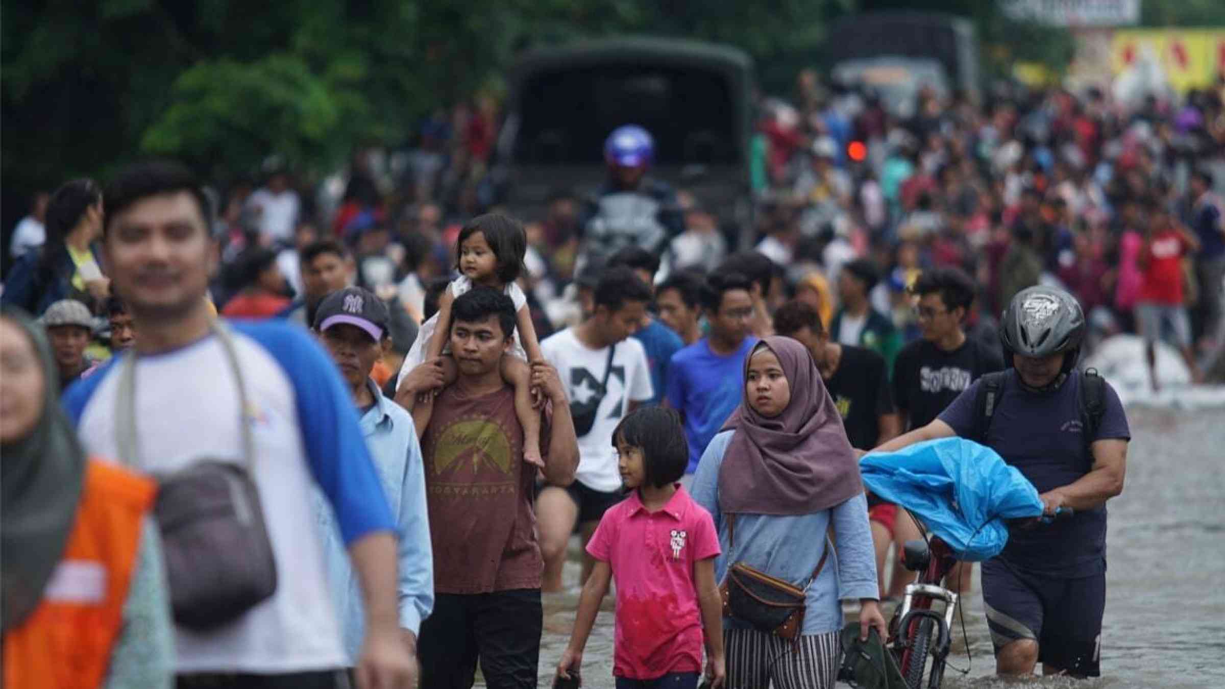 Commuters wade knee deep floods in Jakarta, Indonesia