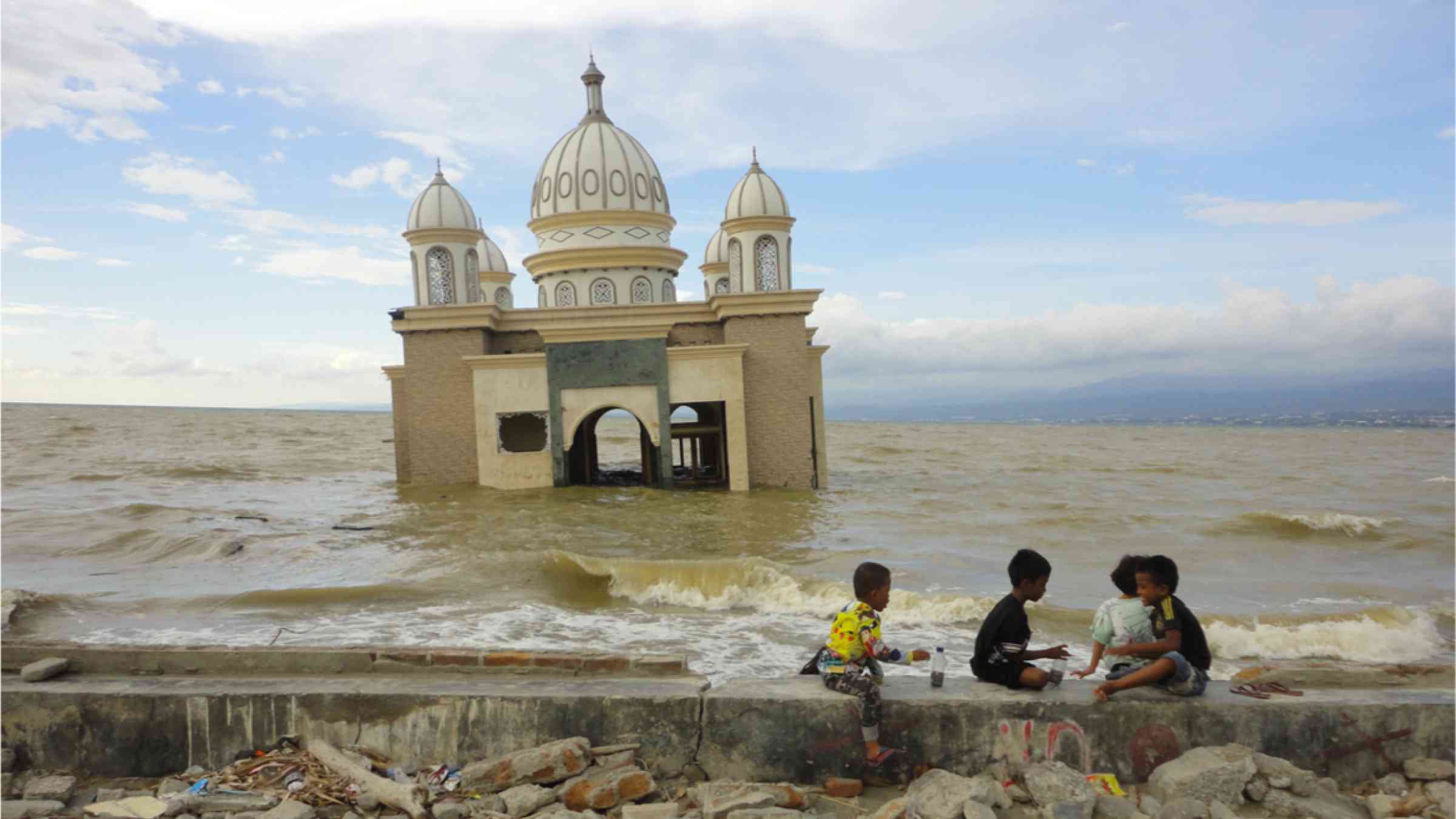 A mosque lies partially submerged in Palu, Indonesia after the 2018 Sulawesi earthquake and tsunami.