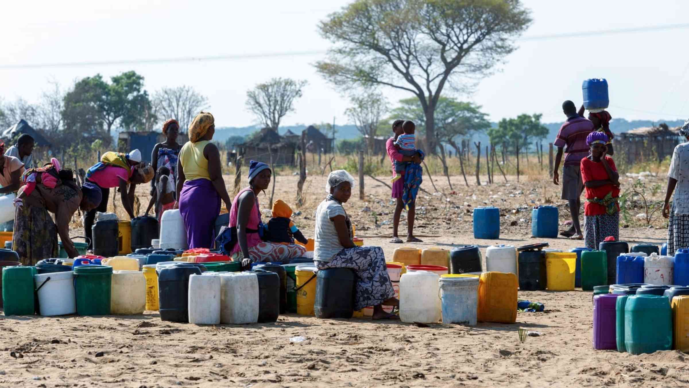  Unidentified Namibian woman with child near public tank with drinking water, Namibia (2014)