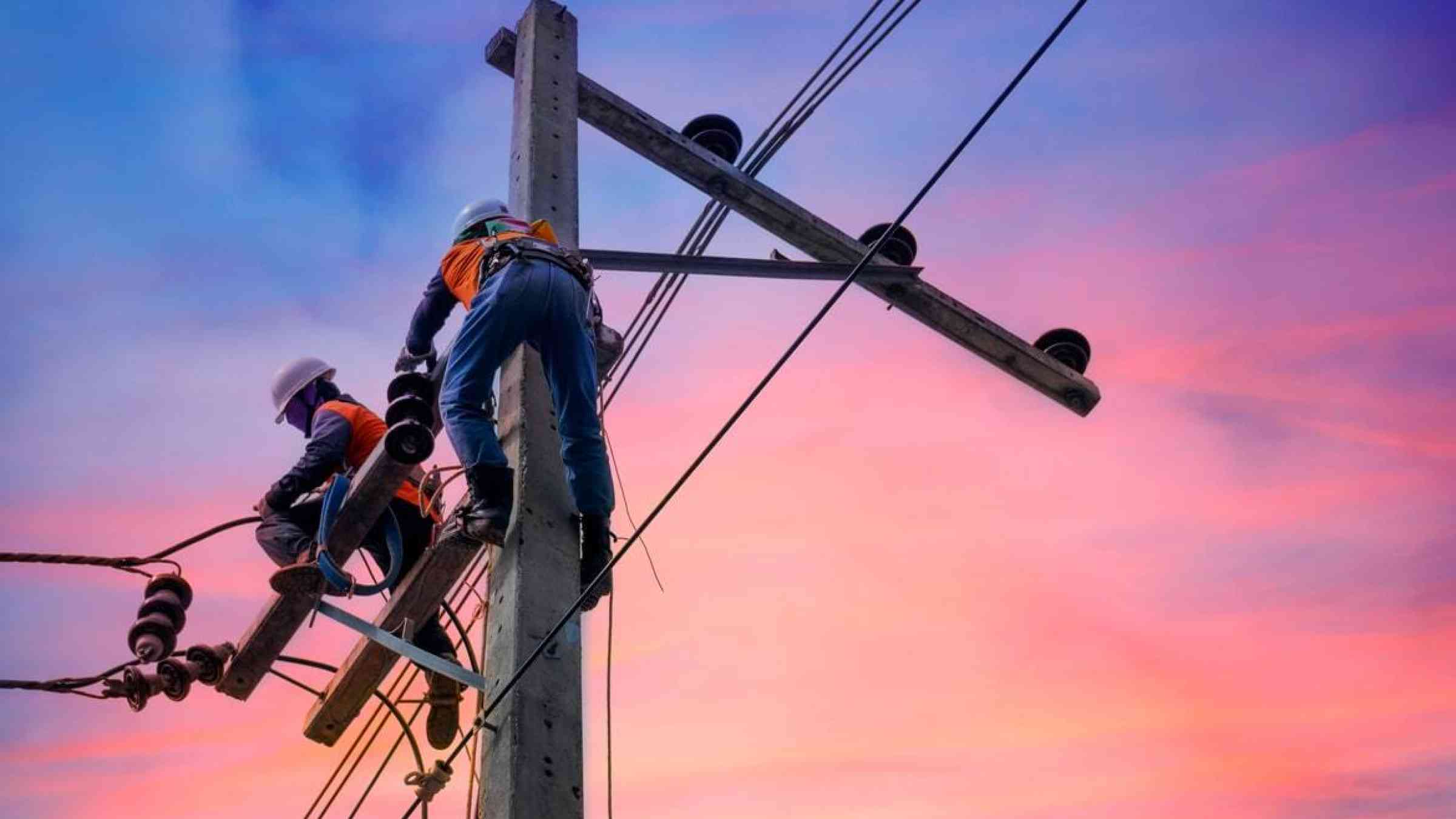 Electric line personnel conduct maintenance work on power lines