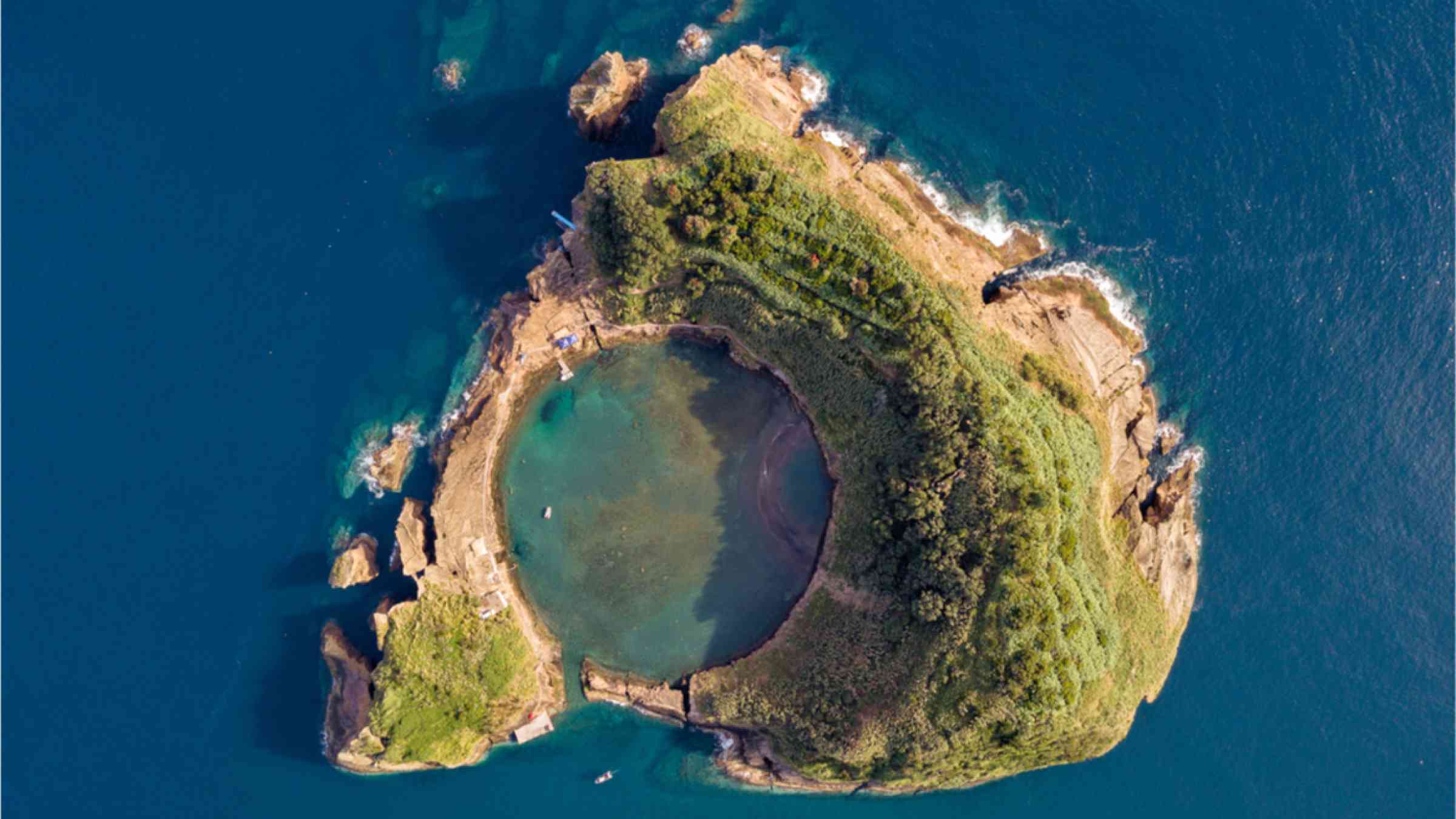 Bird's eye view of Vila Franca do Campo island with a crater of an ancient underwater volcano.