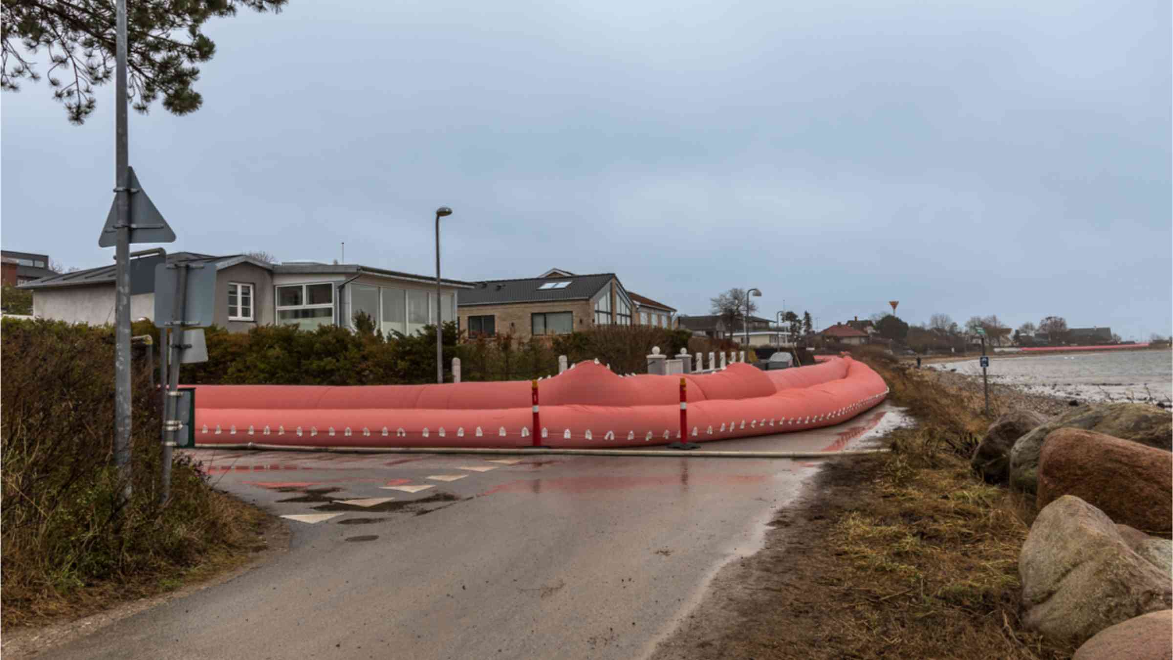 Pink water tube on the shore in Frederikssund in Denmark to prevent flooding from Storm Malik.
