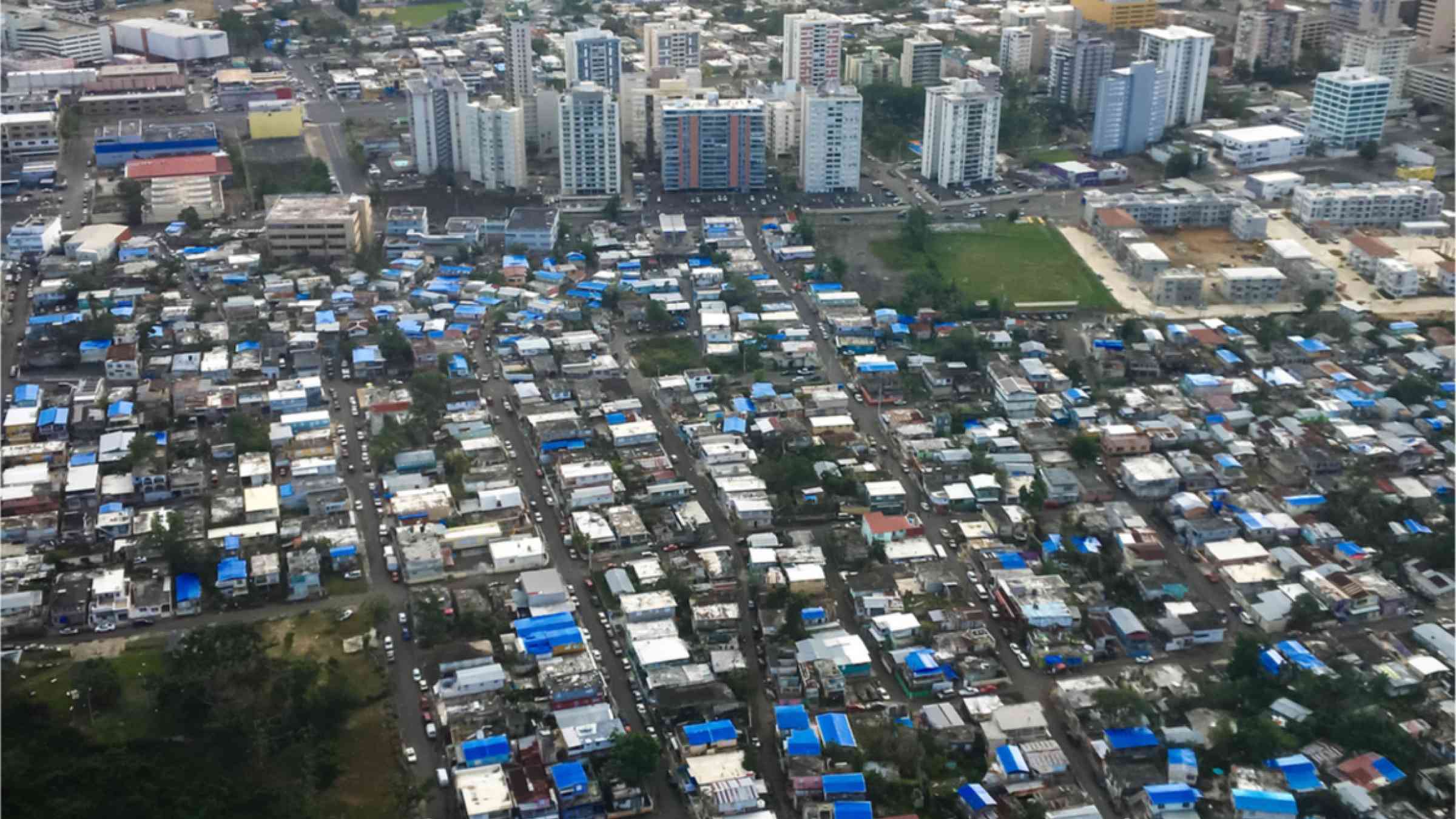 Blue tarps cover damaged roofs in San Juan, Puerto Rico after Hurricane Maria in September 2017.