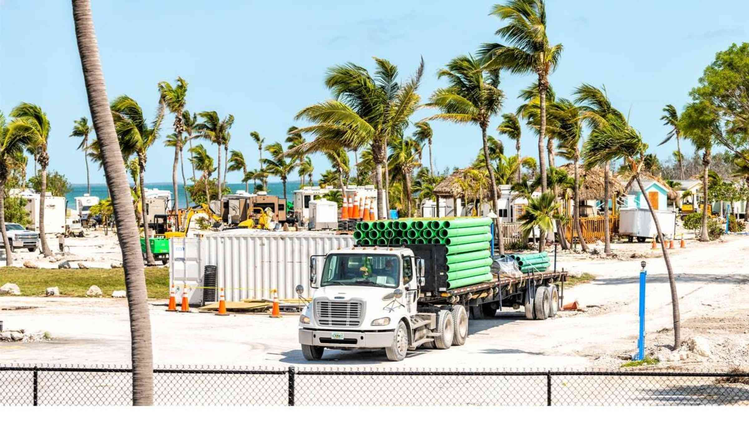 Truck on a post-disaster reconstruction site on a tropical coast