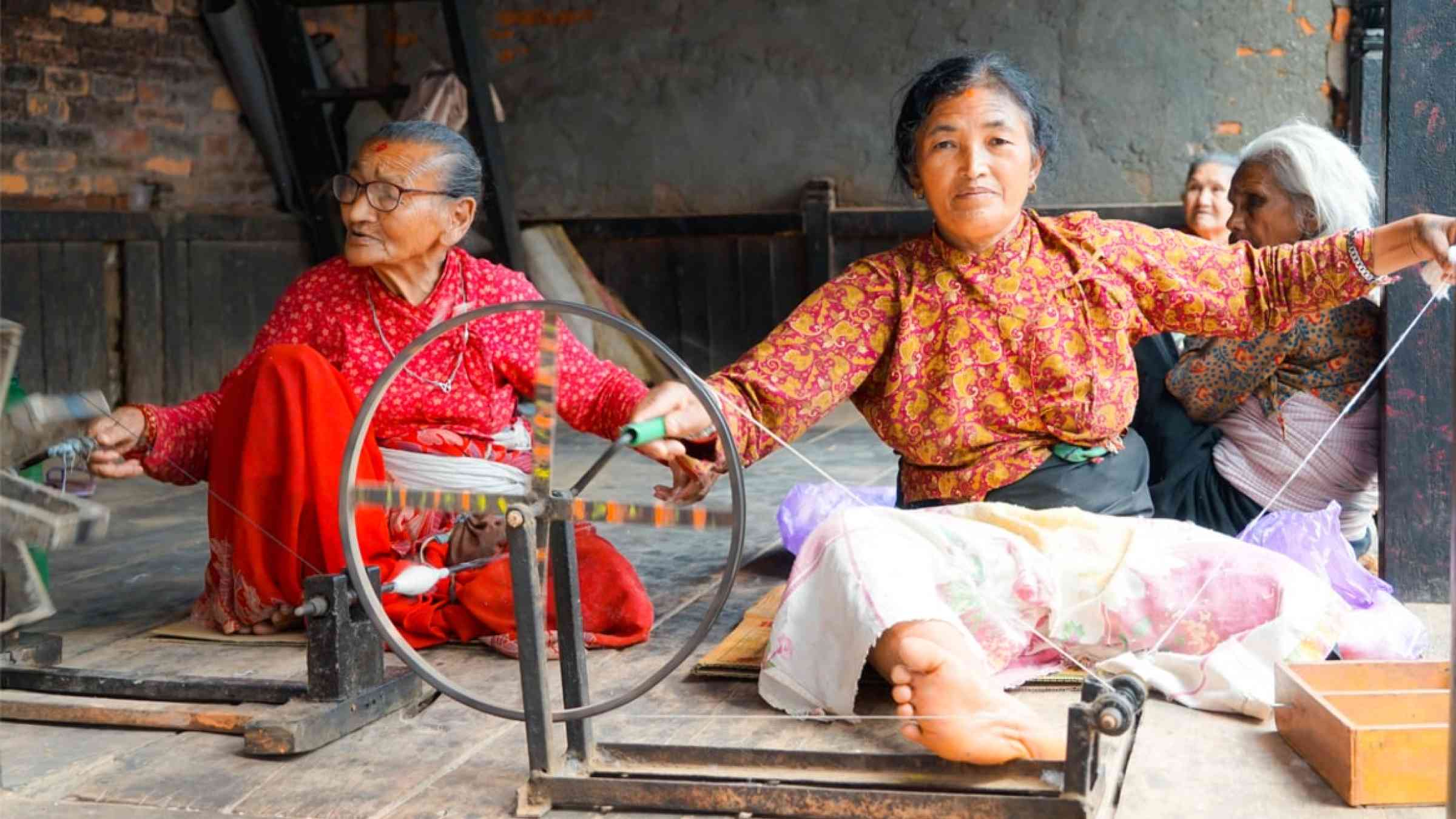 Women are spinning wool in a workshop in Bahaktapur, Nepal
