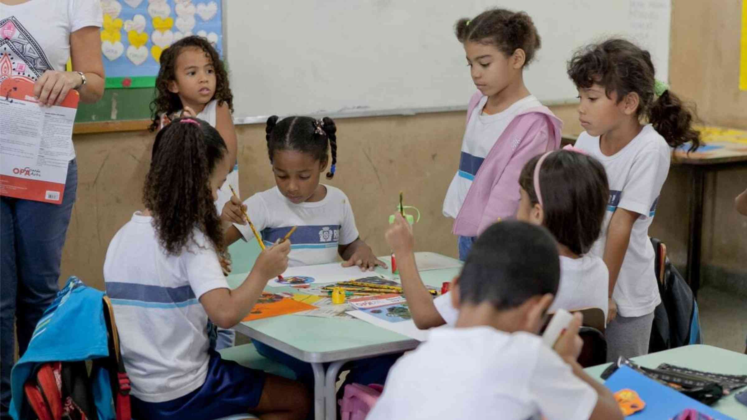 Young students in a classroom at their desks doing group work