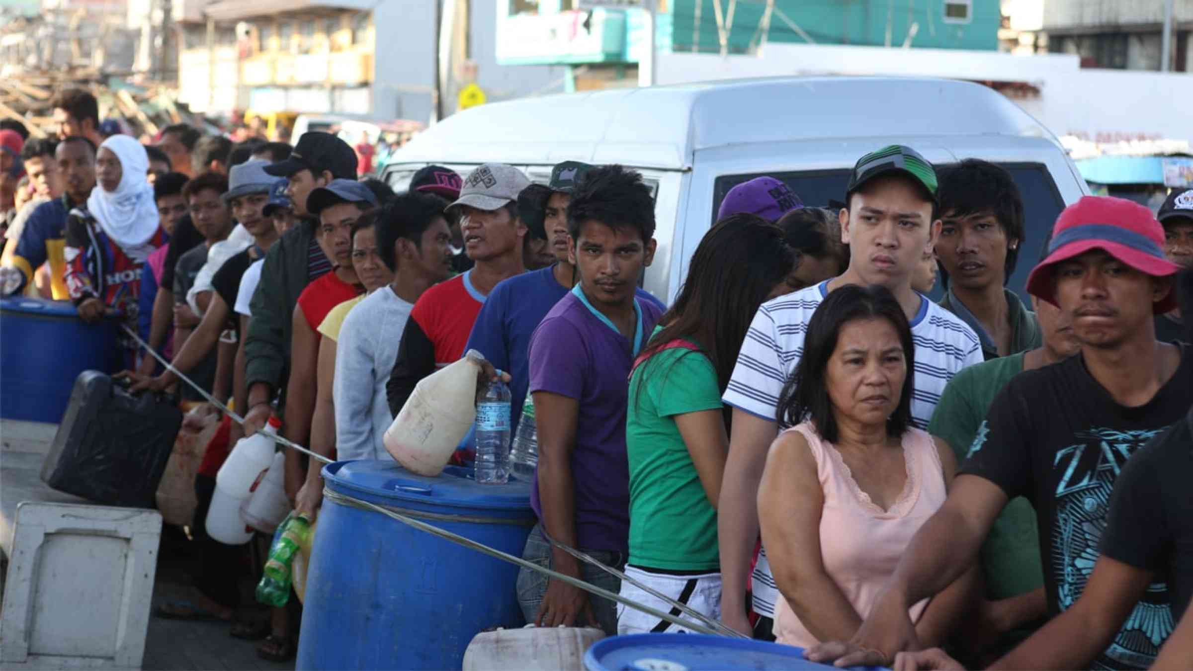 People waiting in line after Typhoon Haiyan in Tacloban, Philippines (2013)
