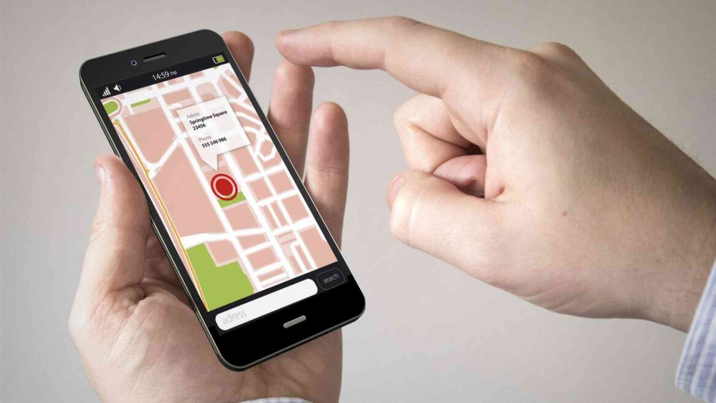 Hands using a smartphone, displaying a street map