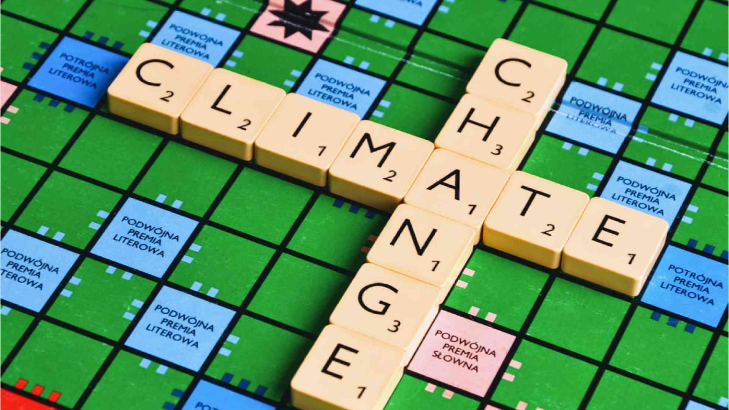 A scrabble board with the words climate change placed on the board.