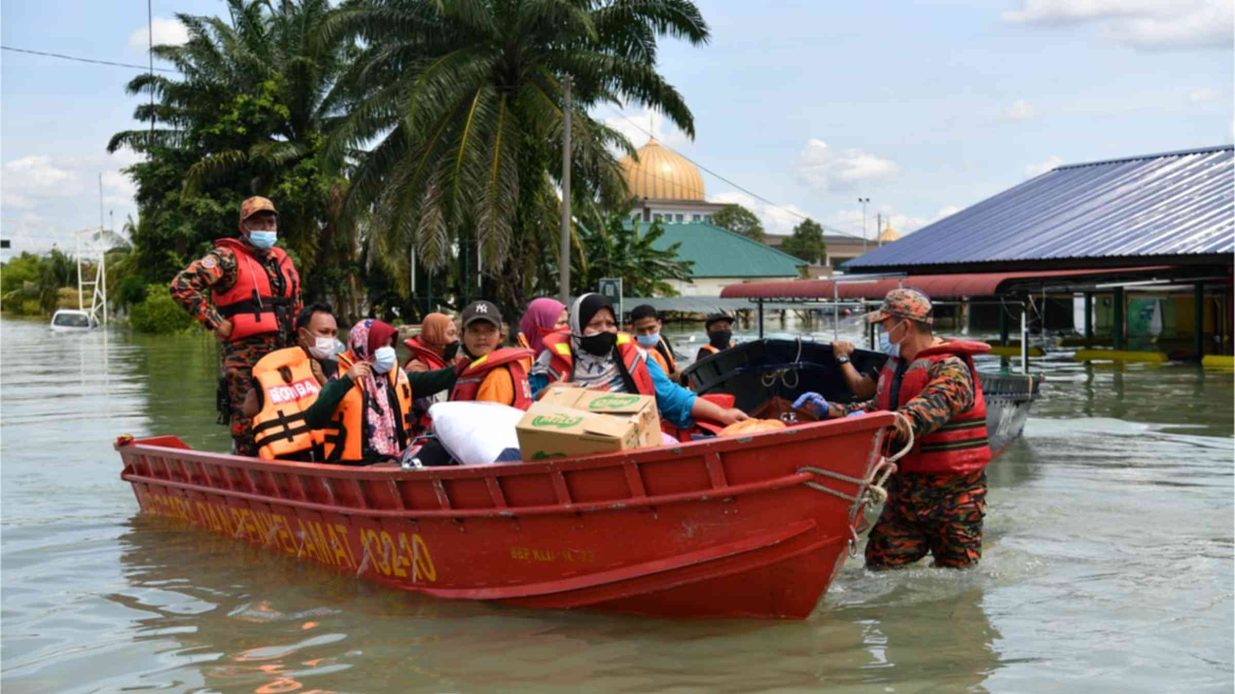 A boat filled with people who are being rescued from the floods in Malaysia.