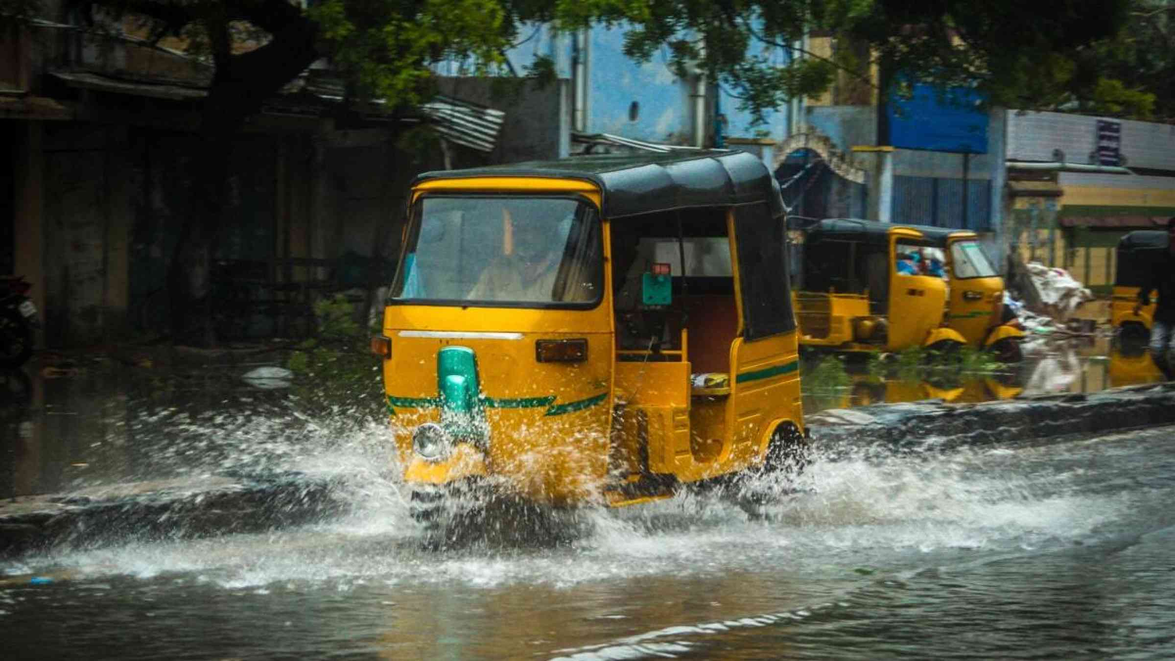Tuktuk driving in a flooded street