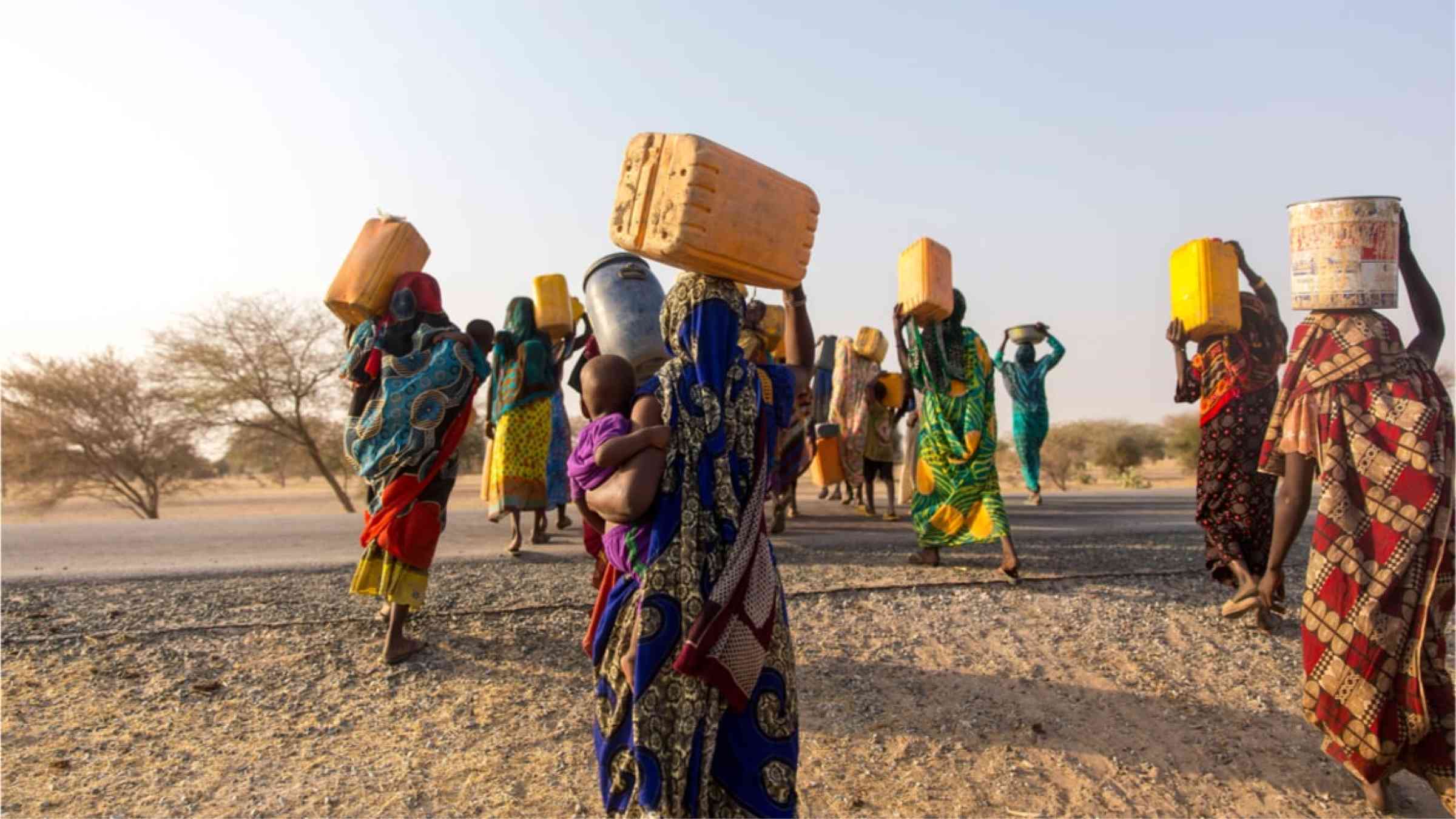 African women carrying water back to their villages.