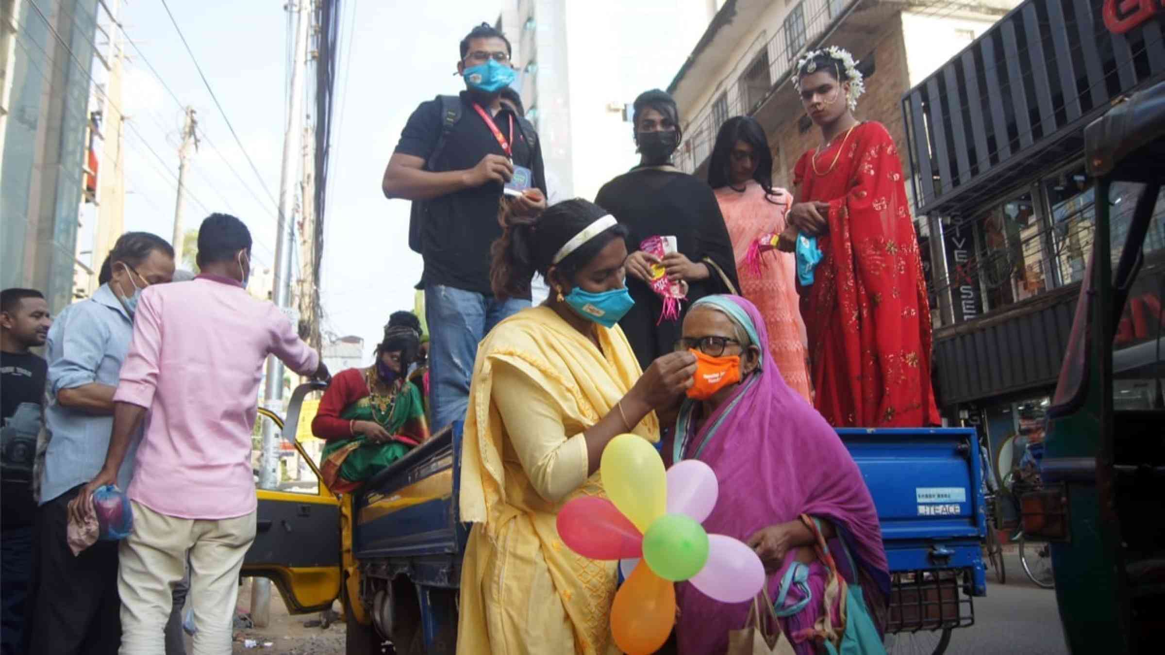  Bangladeshi transgender (third gender) members are distributing leaflets and face mask for health awareness.