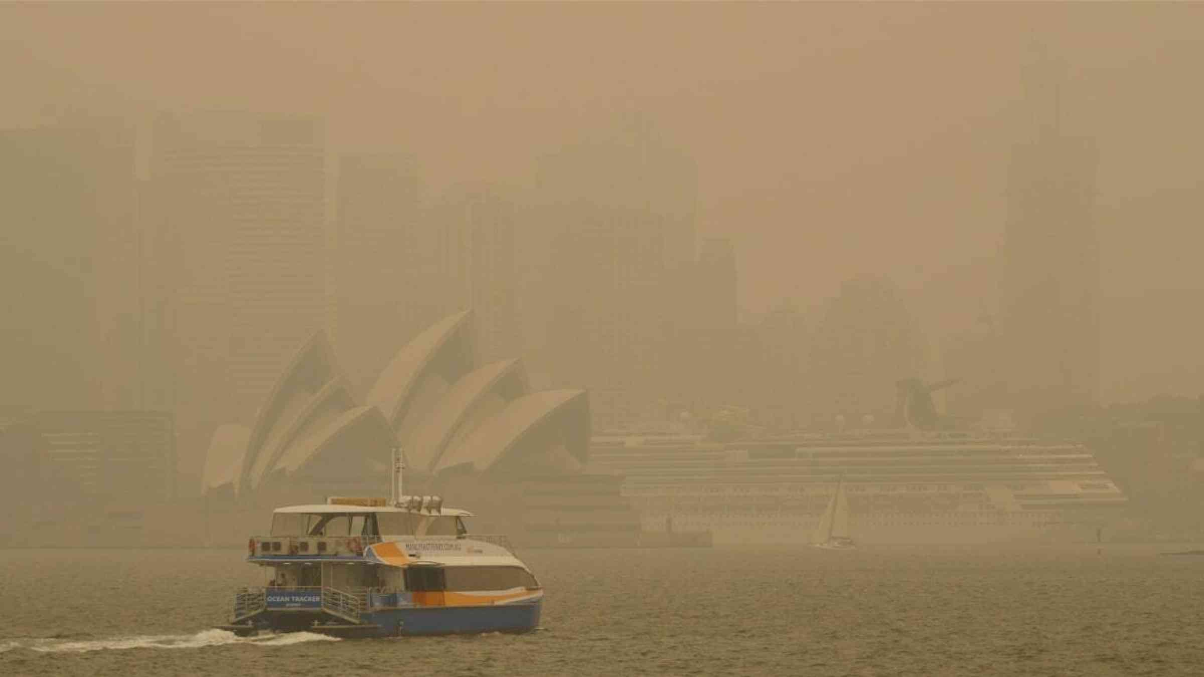 Sydney Harbour landmarks are obscured by smoke from raging bushfires