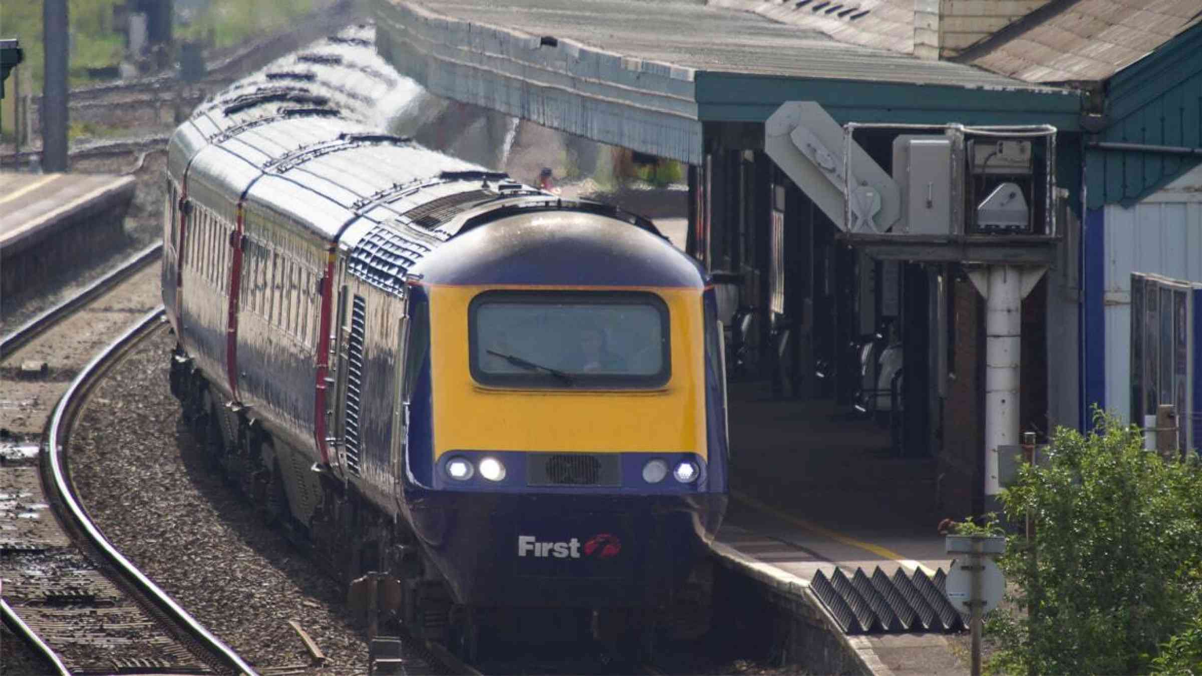 A train waits at an Oxfordshire, UK station in the daytime heat