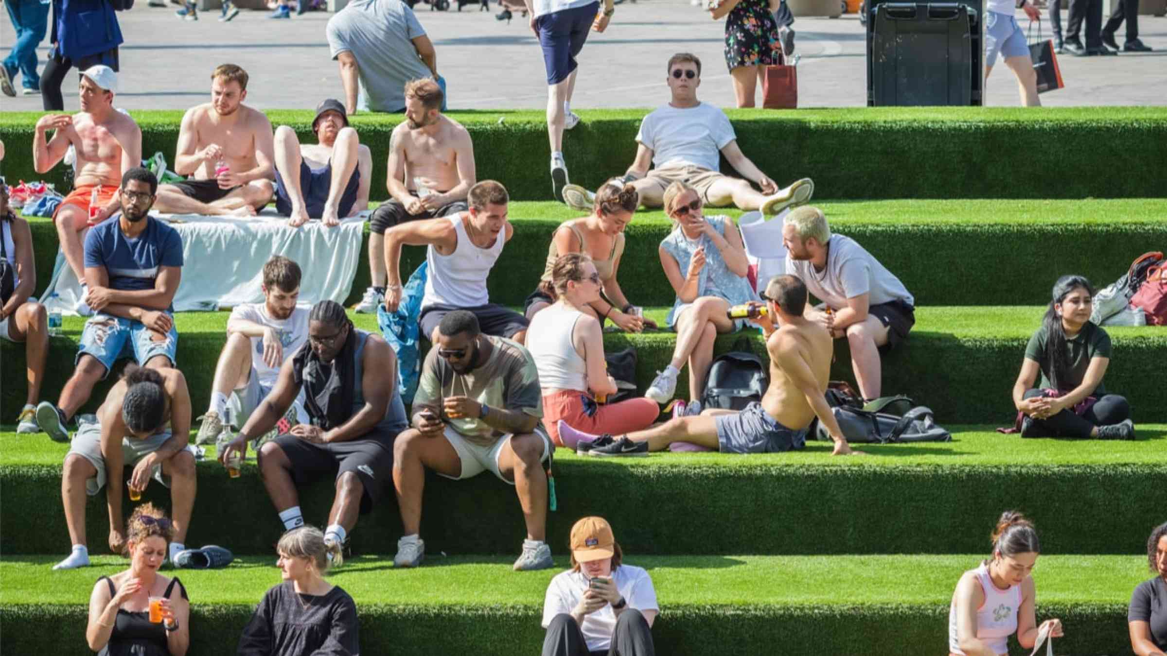 People sitting outside during the UK heatwave